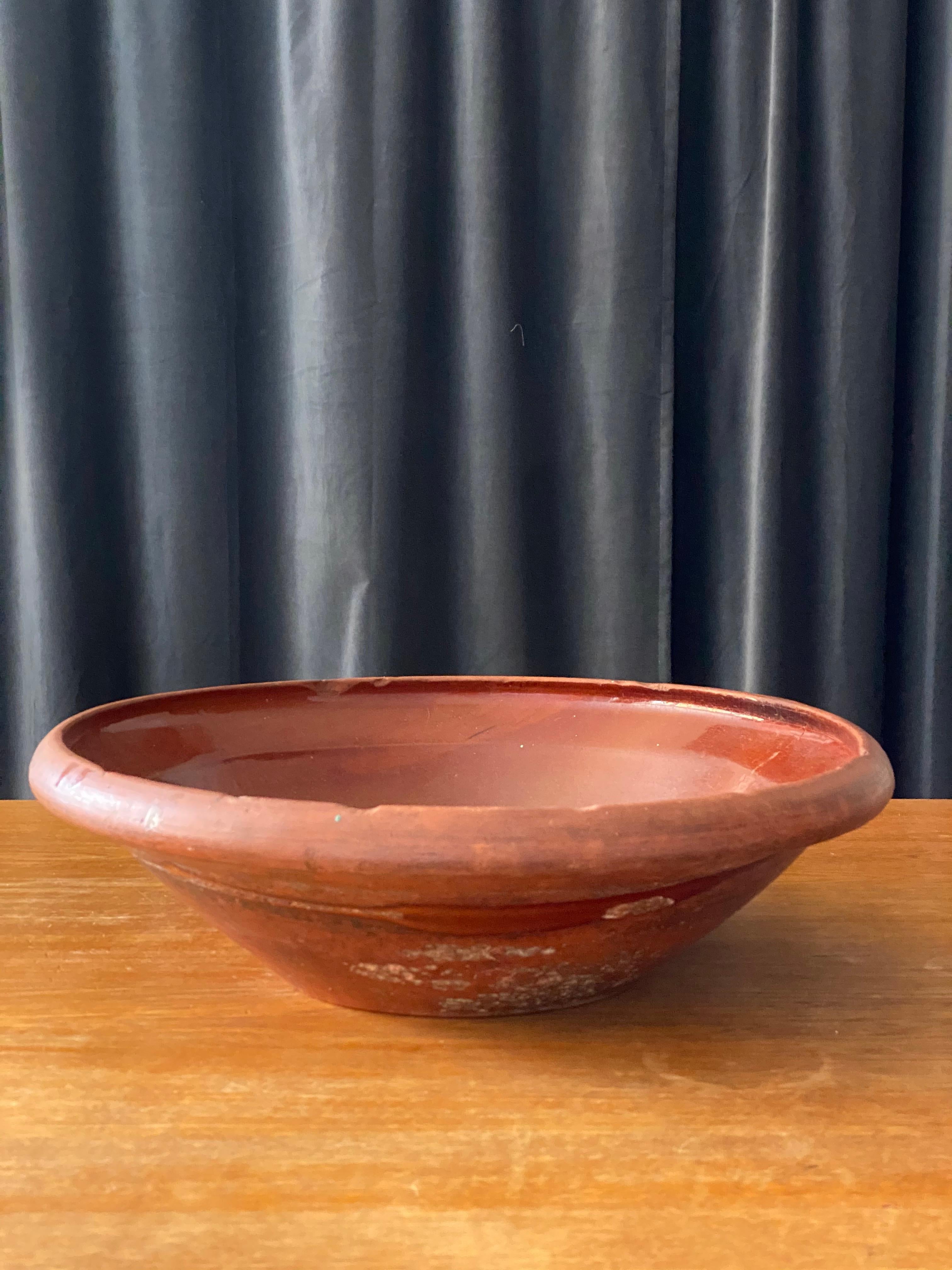An antique and unique large organic and early farmer’s ceramic pottery bowl. Produced in Sweden, 19th century.
 
   