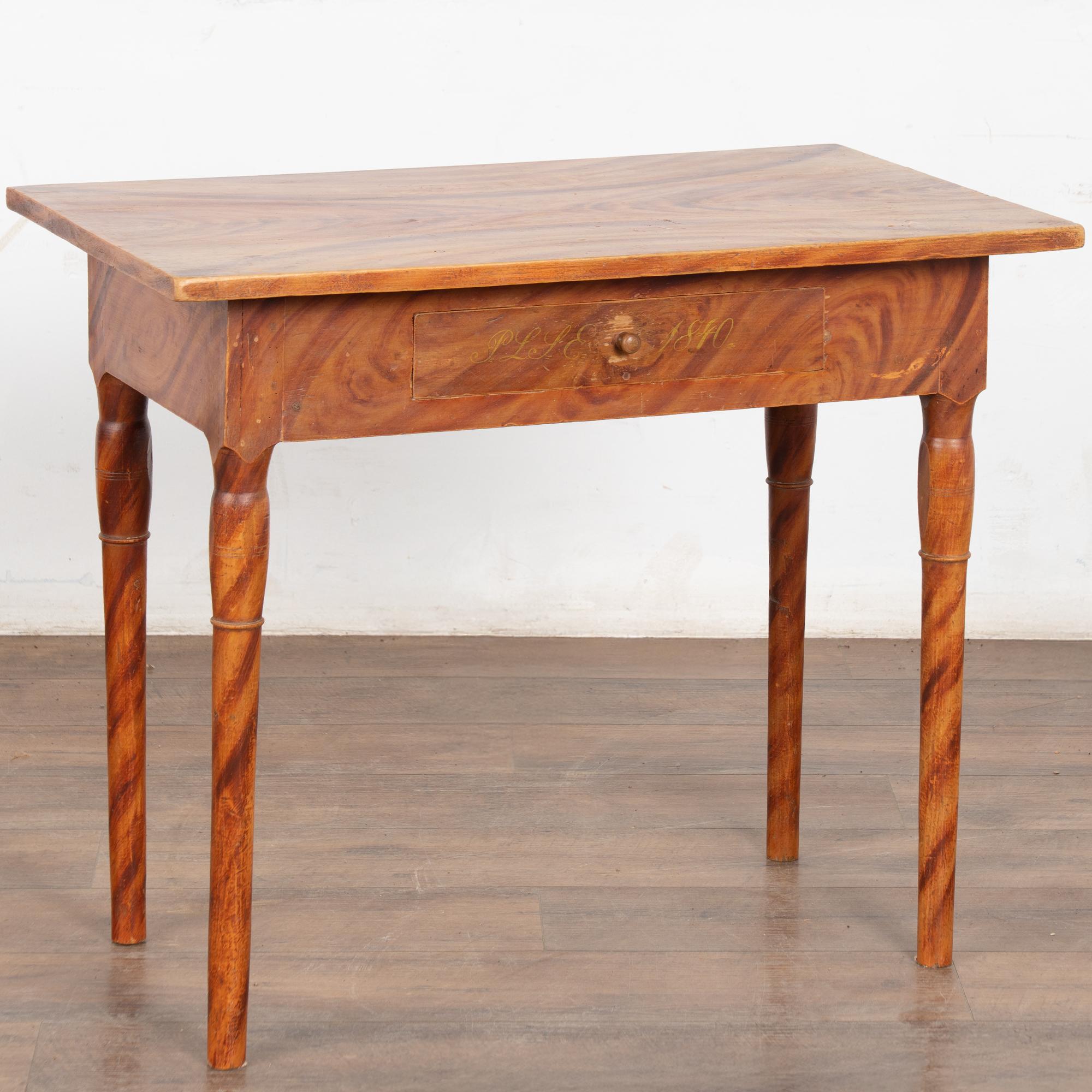 This delightful pine side table comes from the Swedish countryside and still maintains the original faux wood painted finish which was a traditional style of the era.
The single drawer has a monogram and date of 1840 which indicate it may have