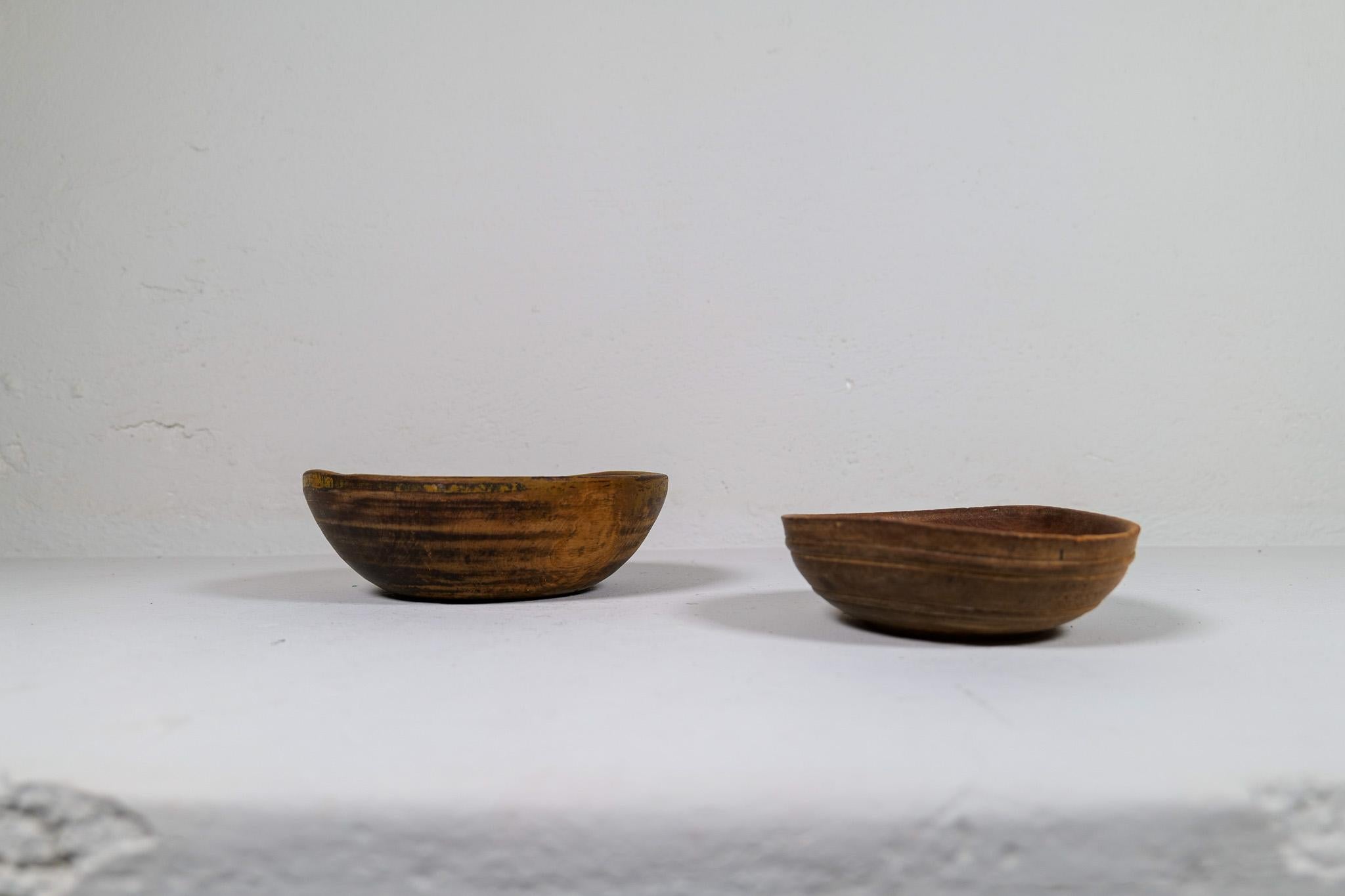 Set of two antique and unique organic wooden bowls. With highly appealing patina, with traces of use. Produced in Sweden, 19th century. 
These bowls where very important for many families; therefore they were passed on from generations. Many of them