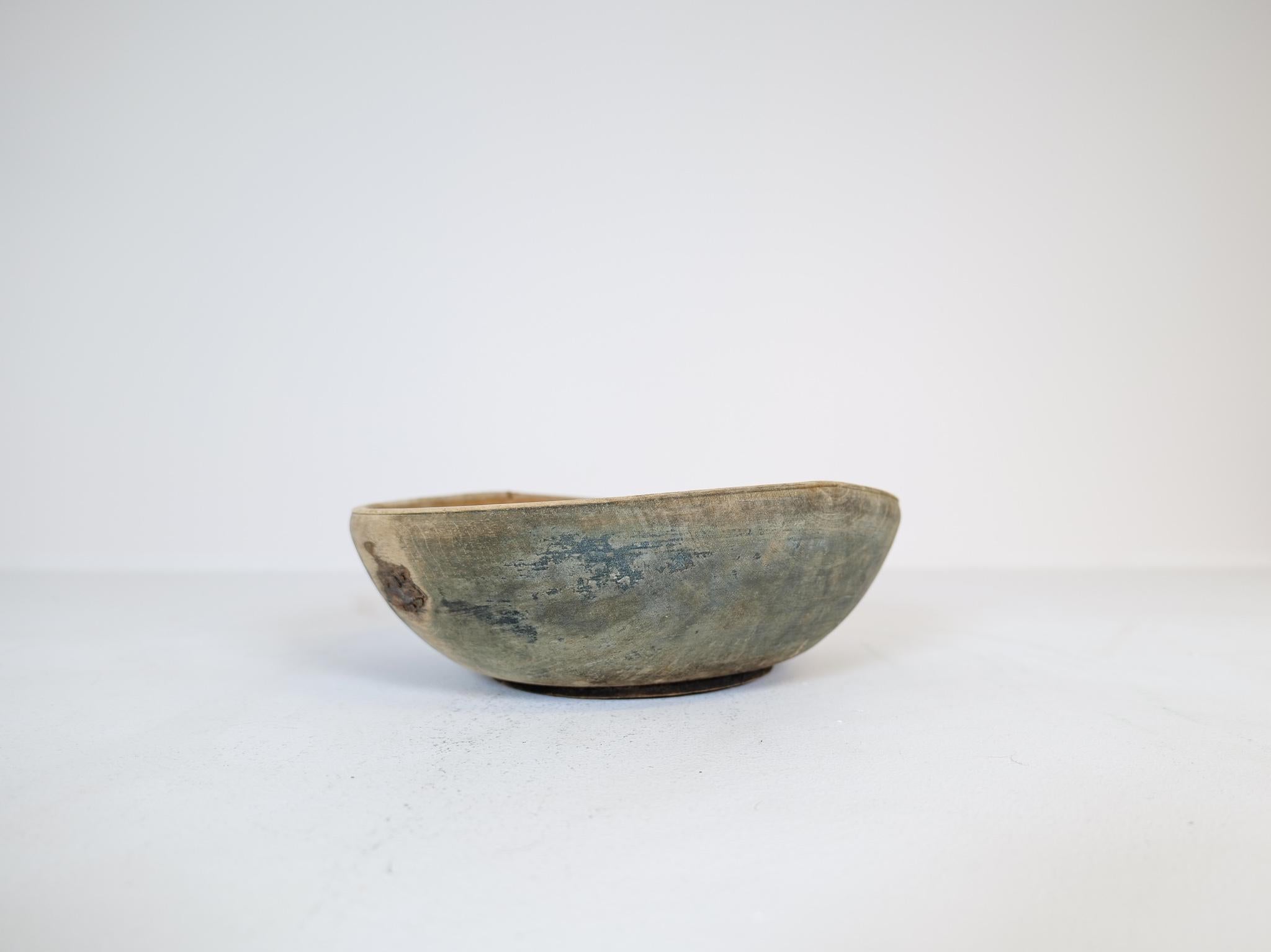 An large antique and unique organic wooden bowl. With highly appealing patina, with traces of use. This one in a unique blue painted color thats been patinated during its time. Produced in Sweden, 19th century. 
These bowls where very important for