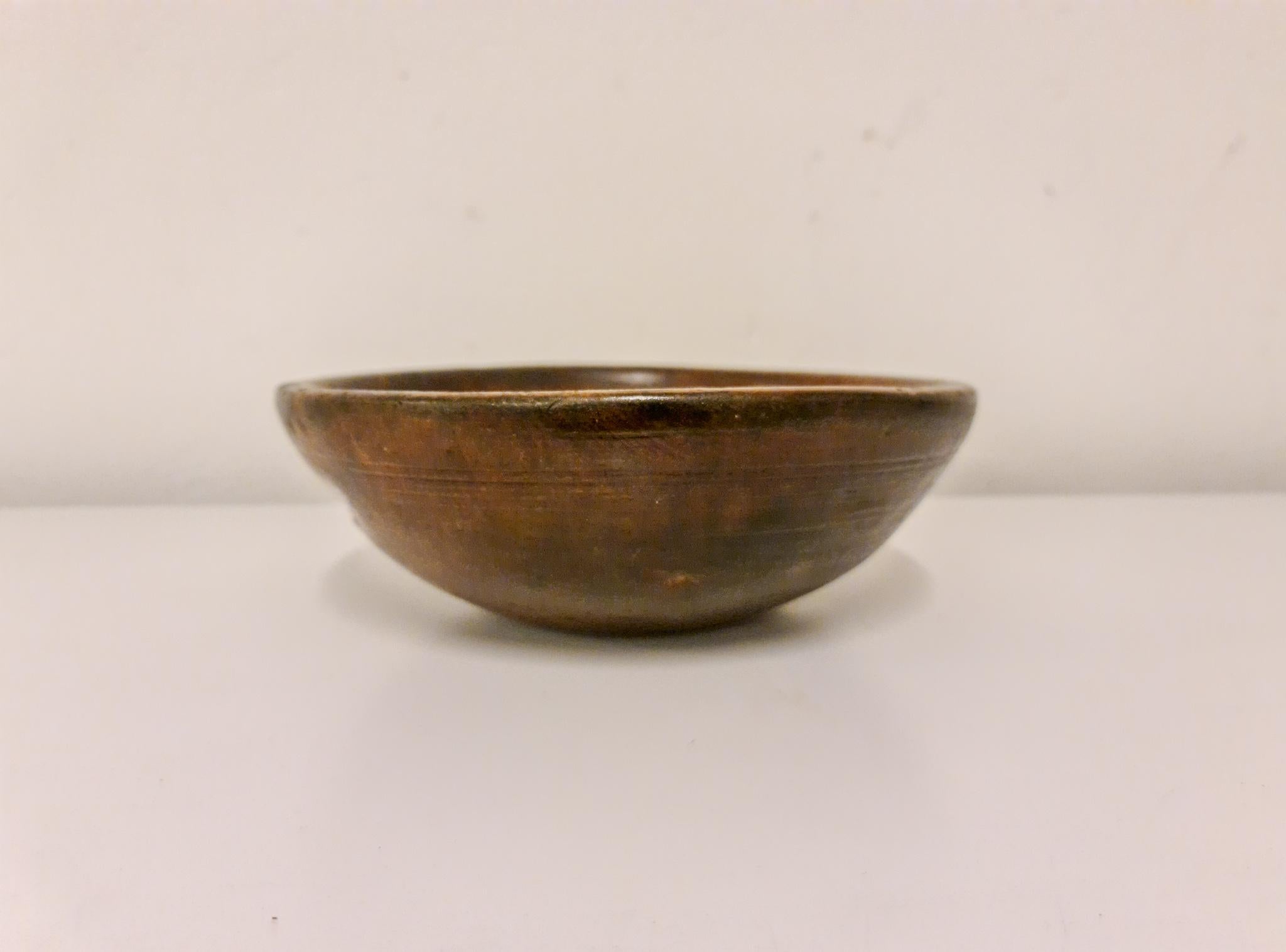 An antique and unique organic wooden bowl. With highly appealing patina, and the inside of the bowl with faded painting makes this a unique and desirable piece. Produced in Sweden, early 19th century. 
These bowls where especially important for