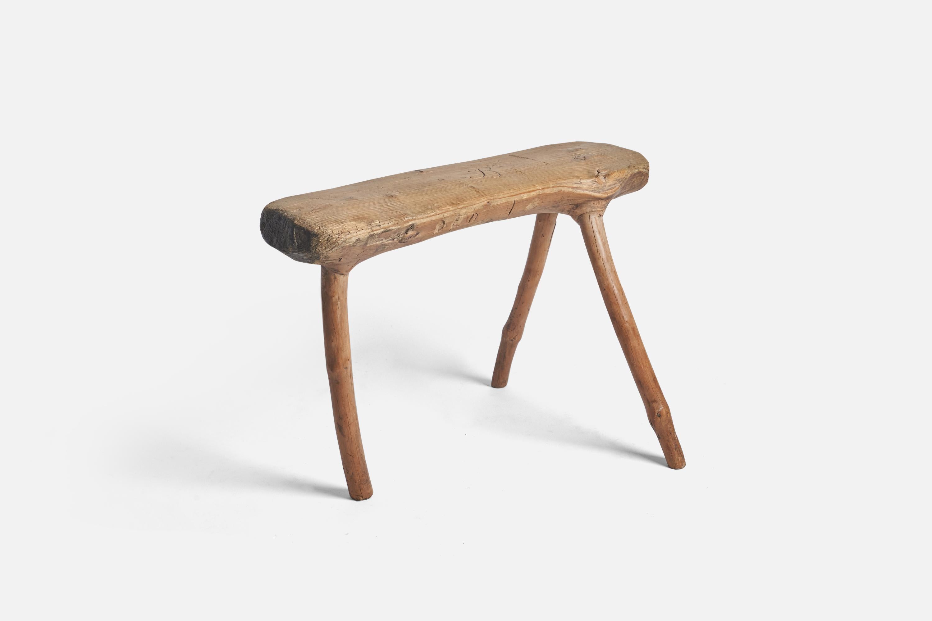 A farmers wooden stool produced in Sweden, 19th century. Signed 