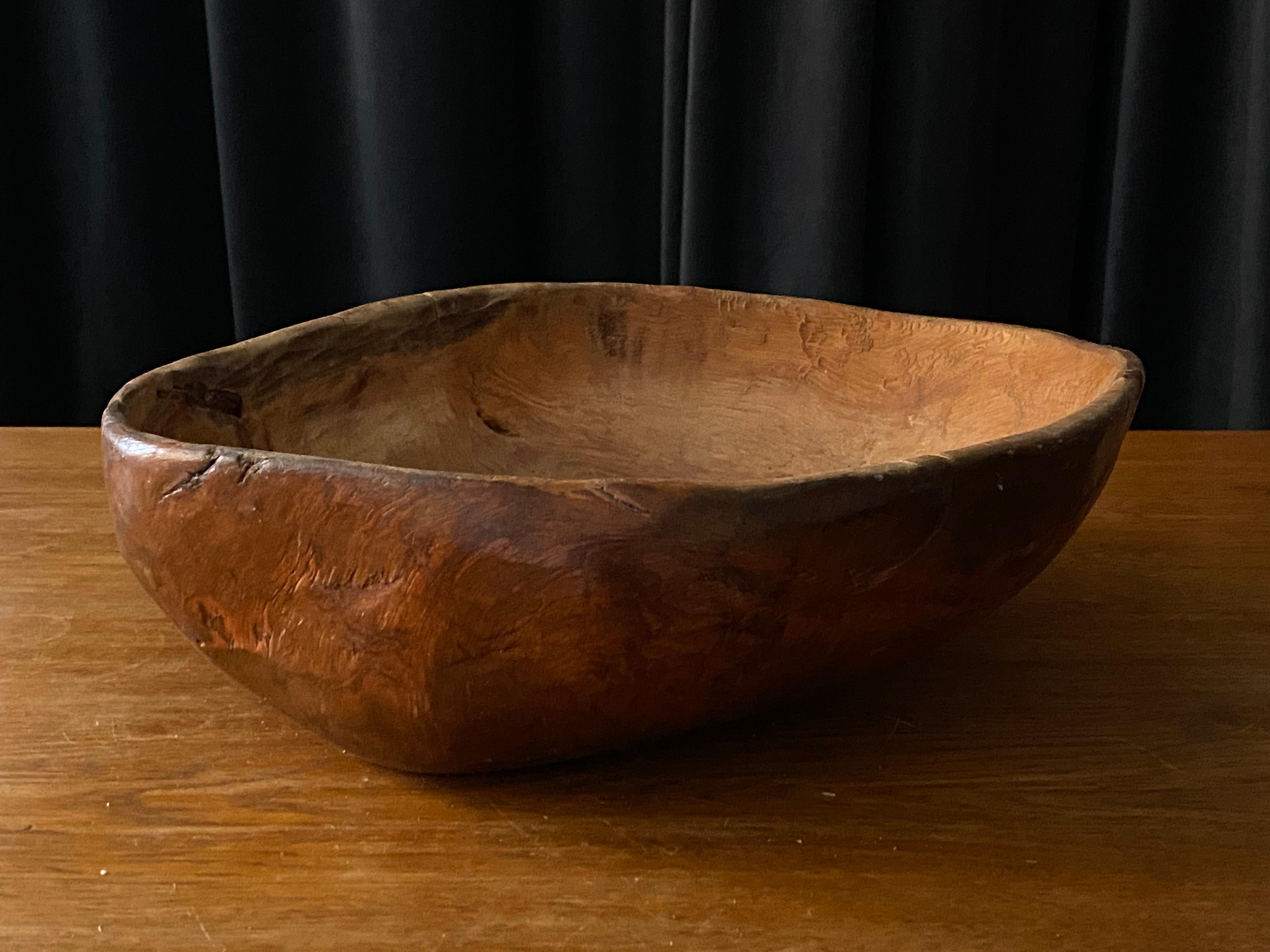 An antique, unique organic and large farmers wooden bowl. With highly appealing patina, Produced in Sweden, 19th century. Features a superb molten tin repair.
  