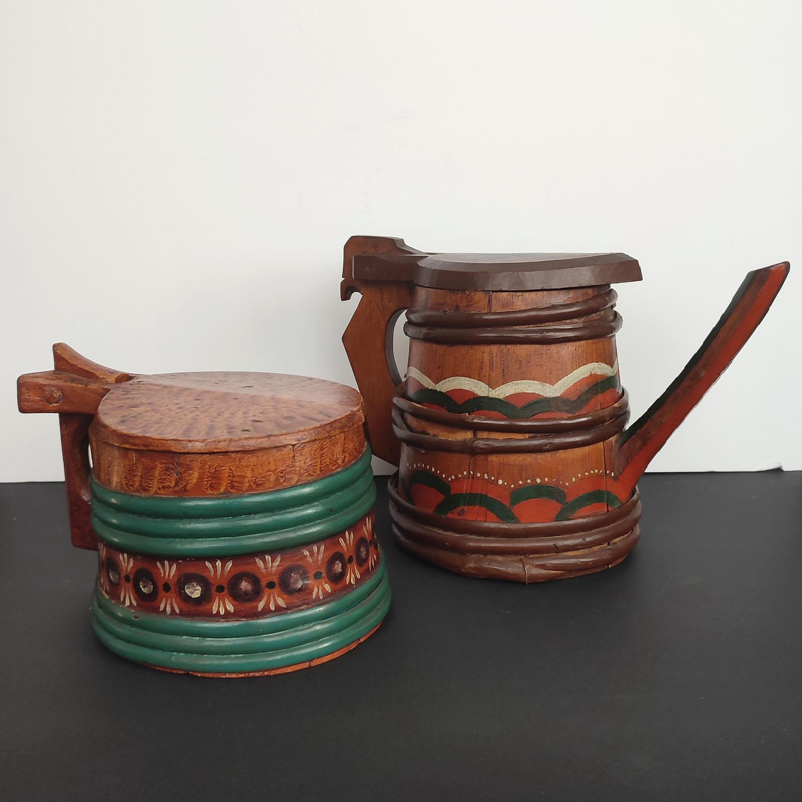 Swedish wooden Lidded Tankard and Pitcher, made of staves that are held together with split-branch banding. The lids are hinged. Both beautifully decorated in blue-green and oxblood red with accents of black and white. 
The pitcher is quite rare,