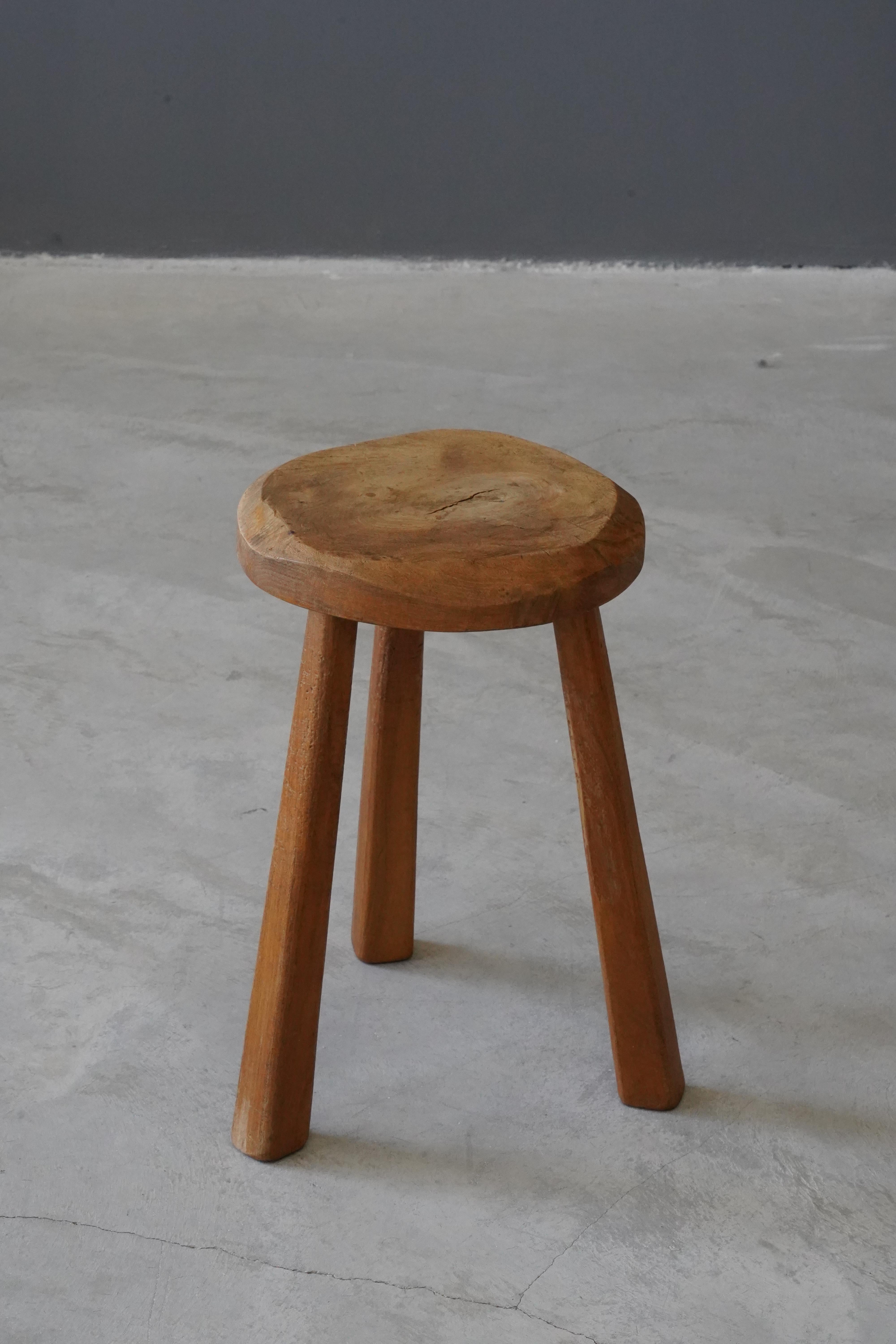A carved free-form stool. Produced in Sweden, c. 1940s. 

  
