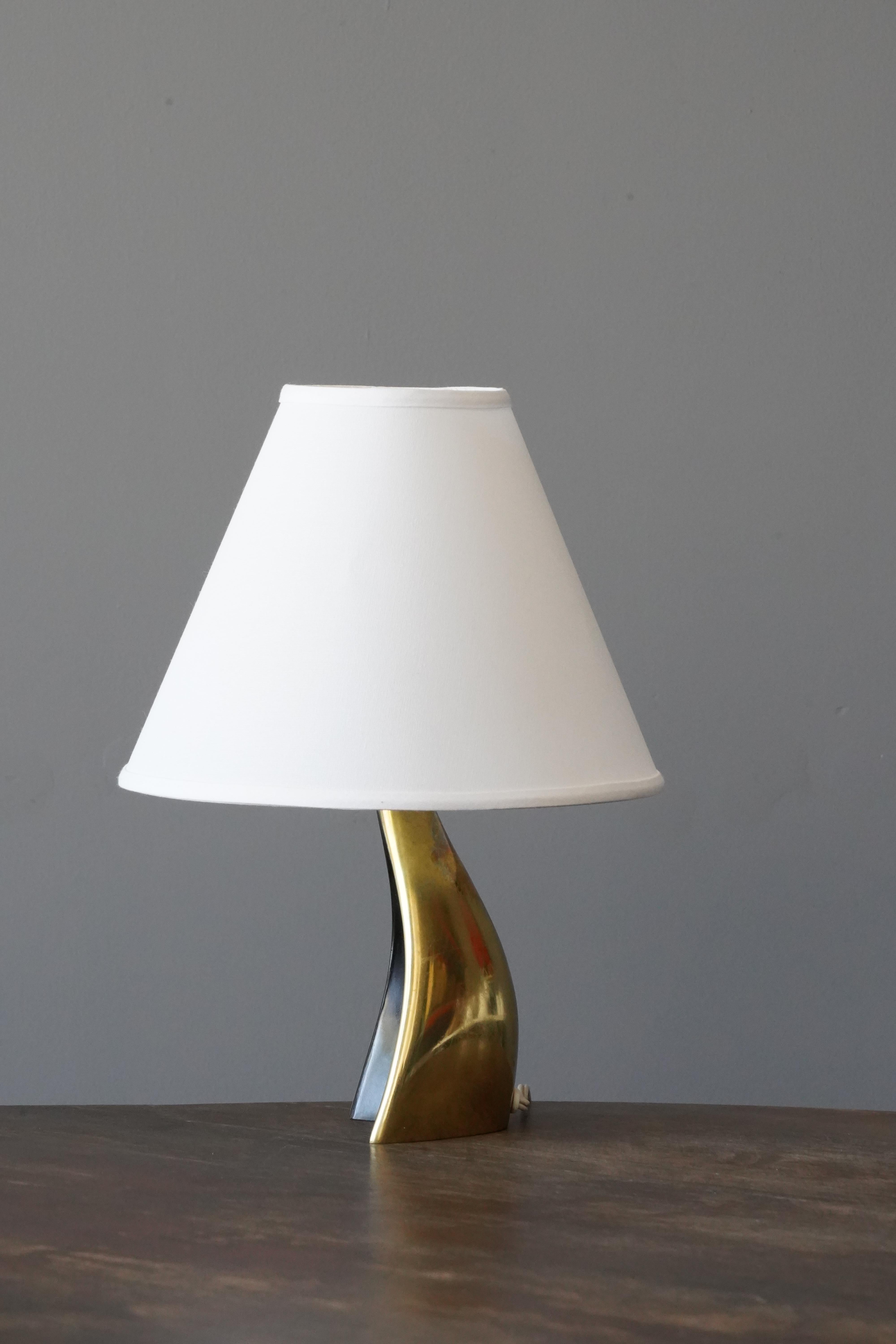 A table lamp, designed and produced in Sweden, circa 1940s-1950s. In partially painted brass.