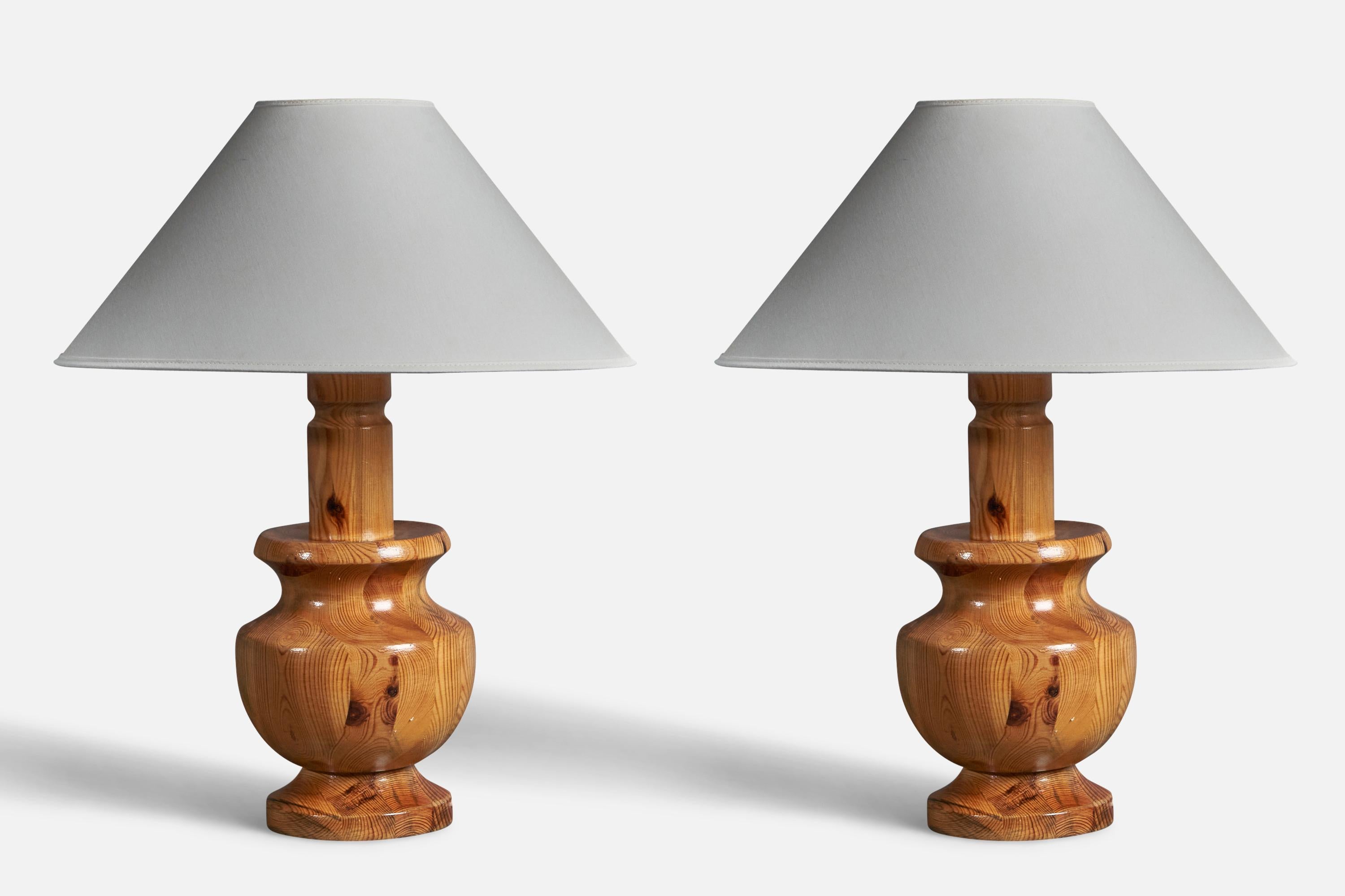 A pair of sizable pine table lamps, designed and produced in Sweden, c. 1960s-1970s. 

Stated dimensions exclude lampshades. Sold without lampshades.