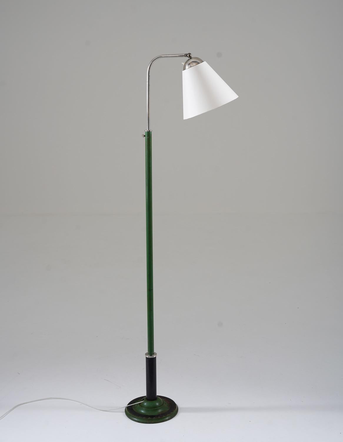 132-180
Lovely early functionalistic floor lamp manufactured in Sweden, 1930s. 
The lamp consists of a green and black iron base, supporting a chrome swivel arm that holds the shade. 
Height is adjustable between 132-180cm (60-70.8”)

Condition: