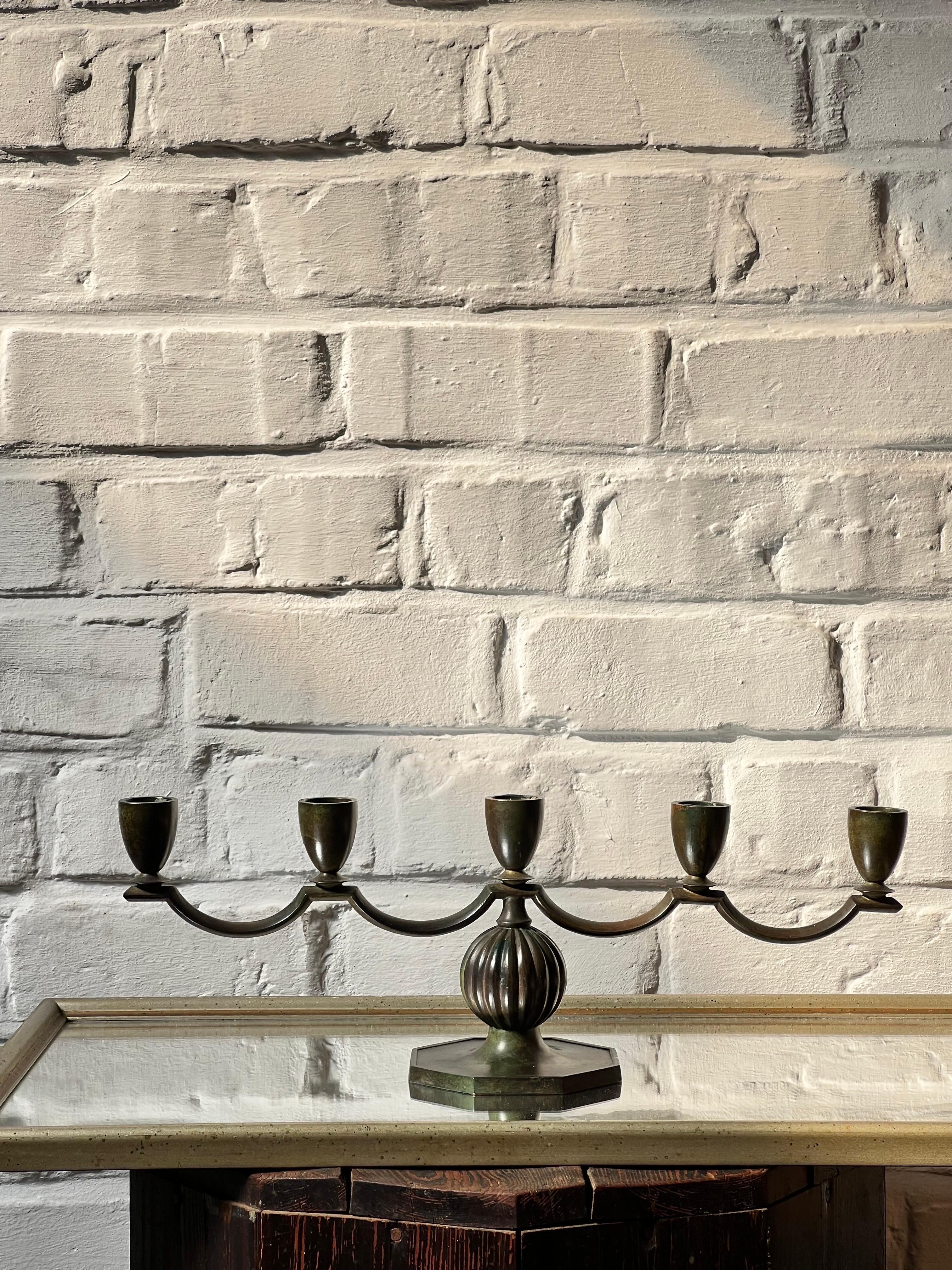 Elegant decorative patinated bronze candelabra fro 5 candles made in Sweden in 1930's by GAB Brons. Part of the Swedish Grace area. Not a candelabra you see very often. Showing some patina with decorative details inspired by the antique Roman and
