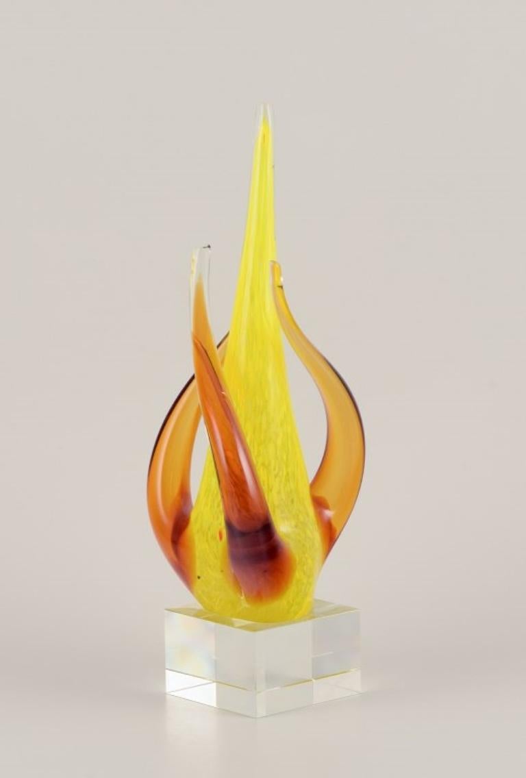 Swedish glass artist. Large sculpture in art glass.
Yellow and amber decoration on a square base in clear glass. Mouth-blown.
Perfect condition.
Late 20th century.
Dimensions: H 33.0 cm x W 12.0 cm.