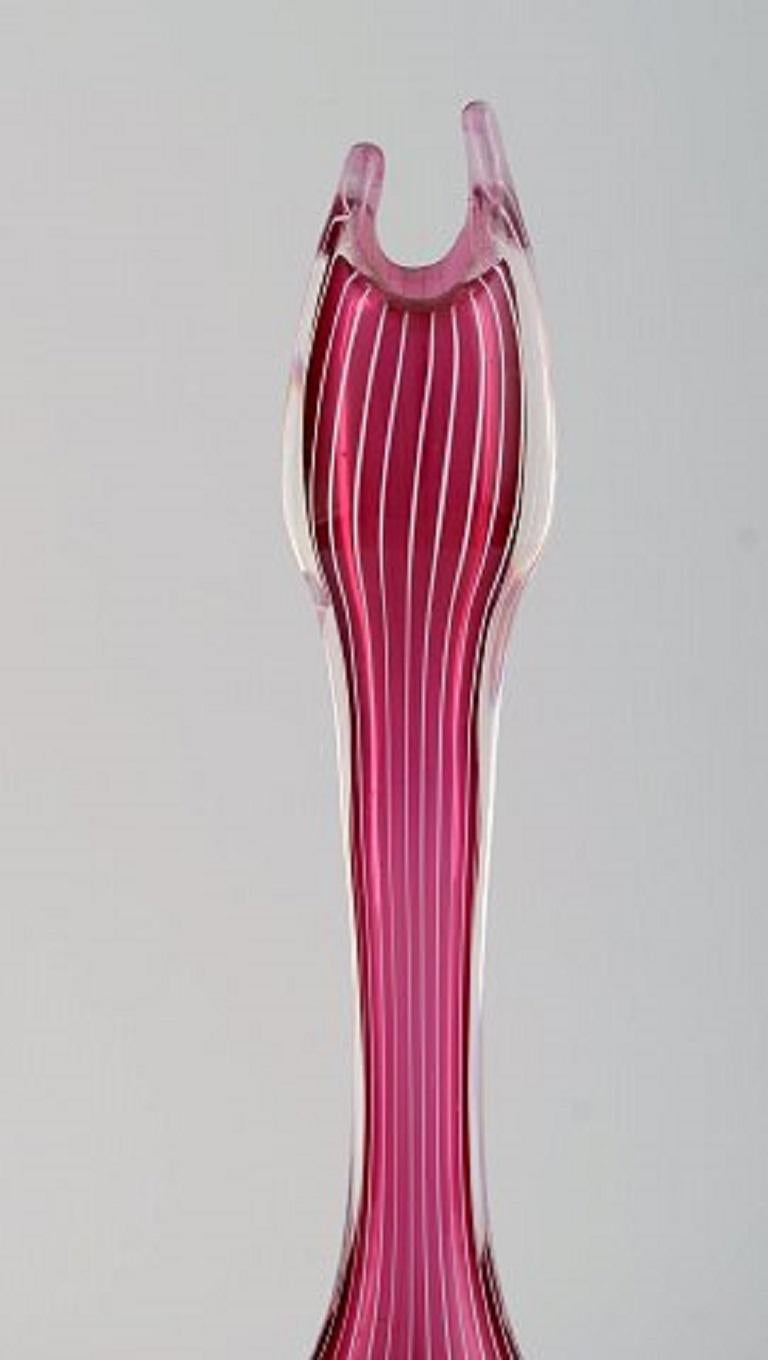 Swedish glass artist. Organically shaped vase in violet and clear mouth-blown art glass with white stripes. Swedish design, mid 20th century.
Measures: 25 x 8 cm.
In excellent condition.