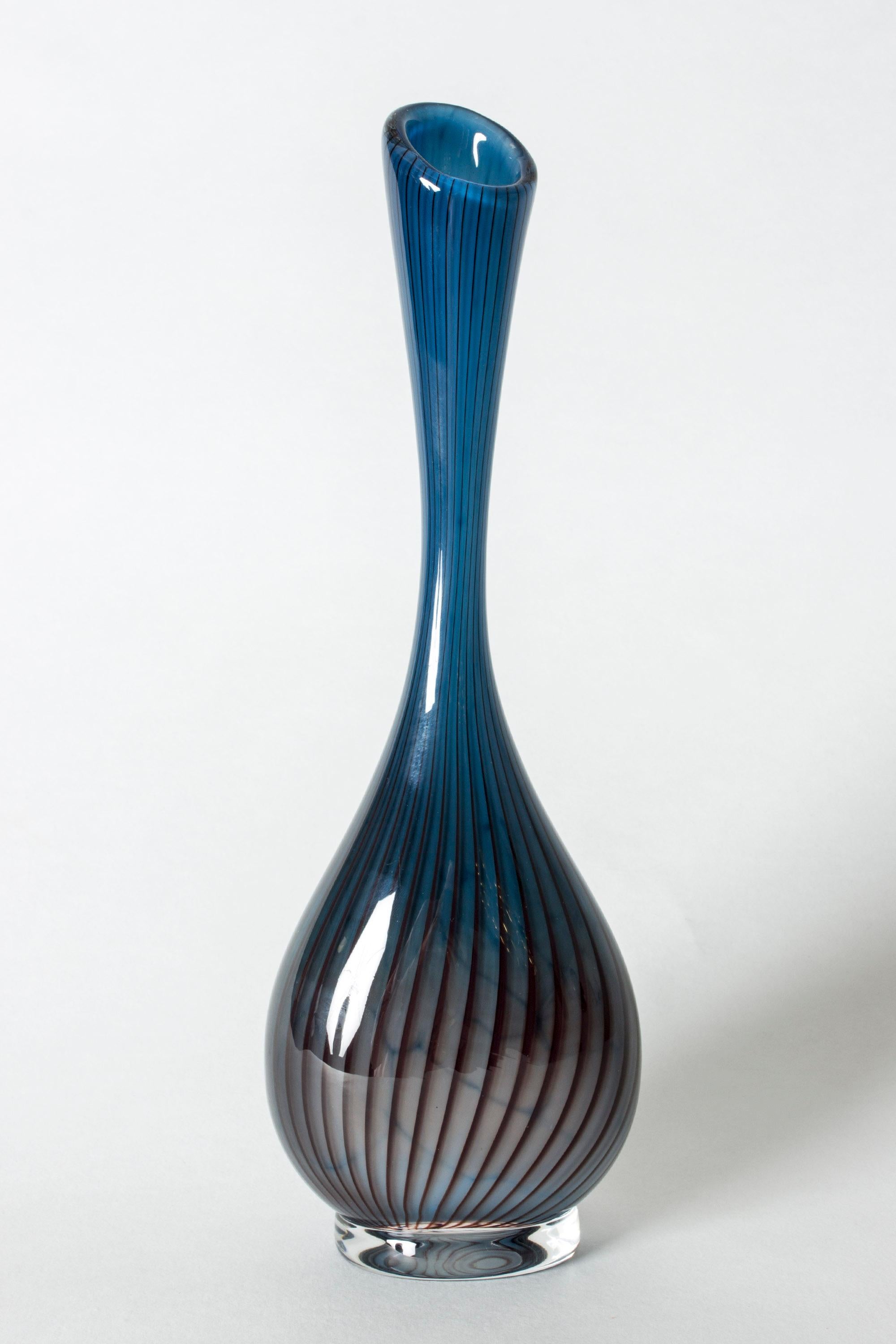 Beautiful glass vase by Vicke Lindstrand, in a smooth, organically streamlined shape. Blue glass with distinct dar stripes that give movement of the vase.
