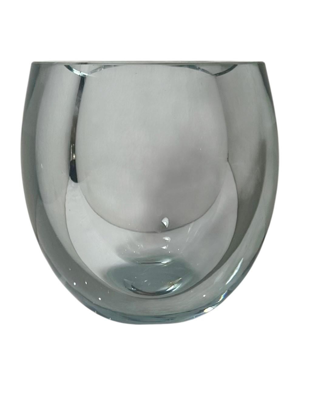 A striking mid century Swedish glass vase, circa 1950s. Expertly crafted with glass over an inch thick, this piece is as substantial as it is beautiful. Its weight, clarity, and clean lines speak to timeless Scandinavian design and ready to anchor