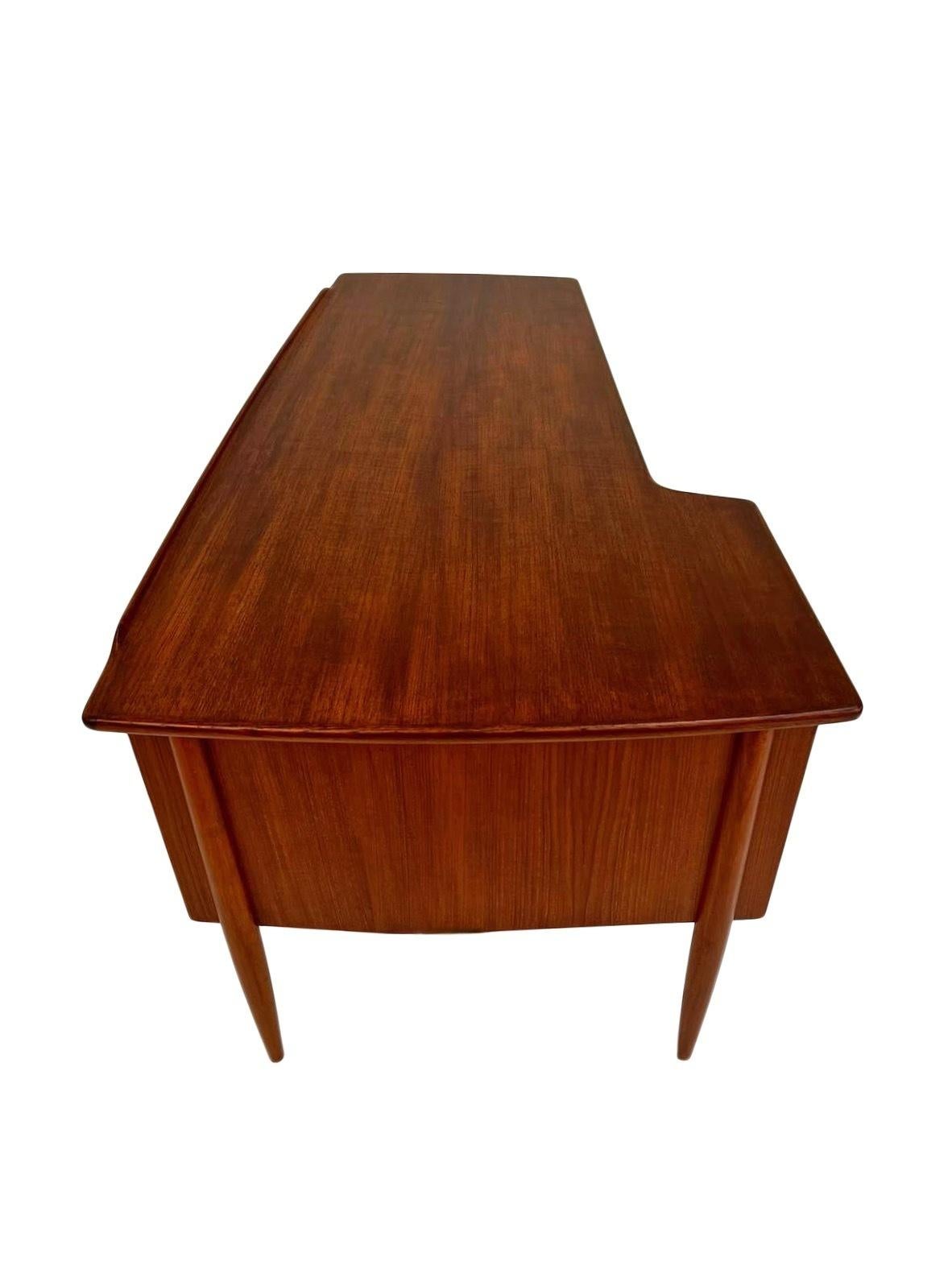An iconic Swedish Model A10 teak writing desk designed by Göran Strand for Lelångs Möbelfabrik, this would make a stylish addition to any work area. A striking piece of classically designed Scandinavian furniture.

The desk has a bank of three