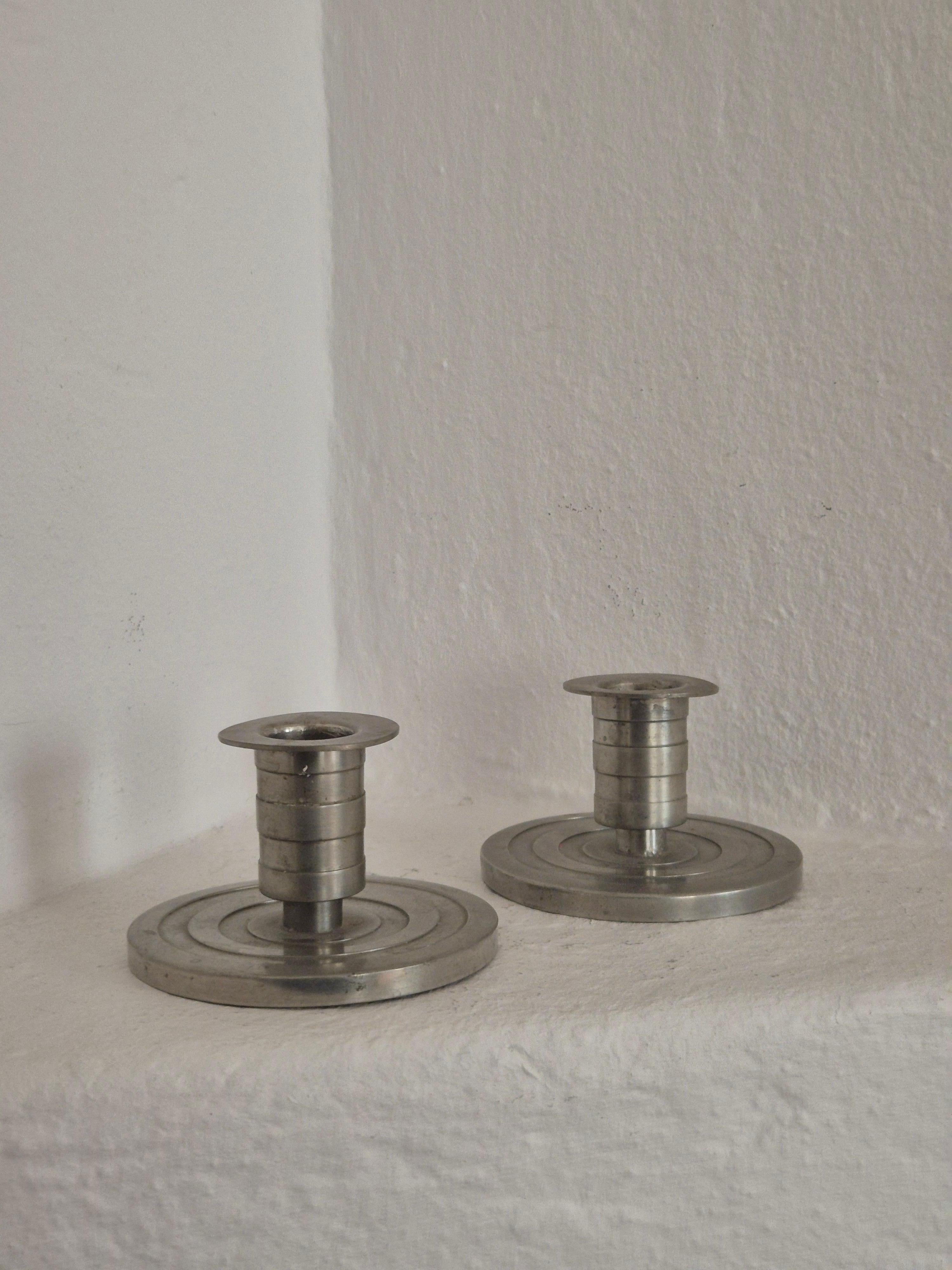 Candle holders in pewter by Sylvia Stave for CG Hallberg, Swedish Grace / Art Deco. With swedish/Stockholm and CGH hallmark, year G8=1933.

In good condition, smaller/normal signs of age and wear.
