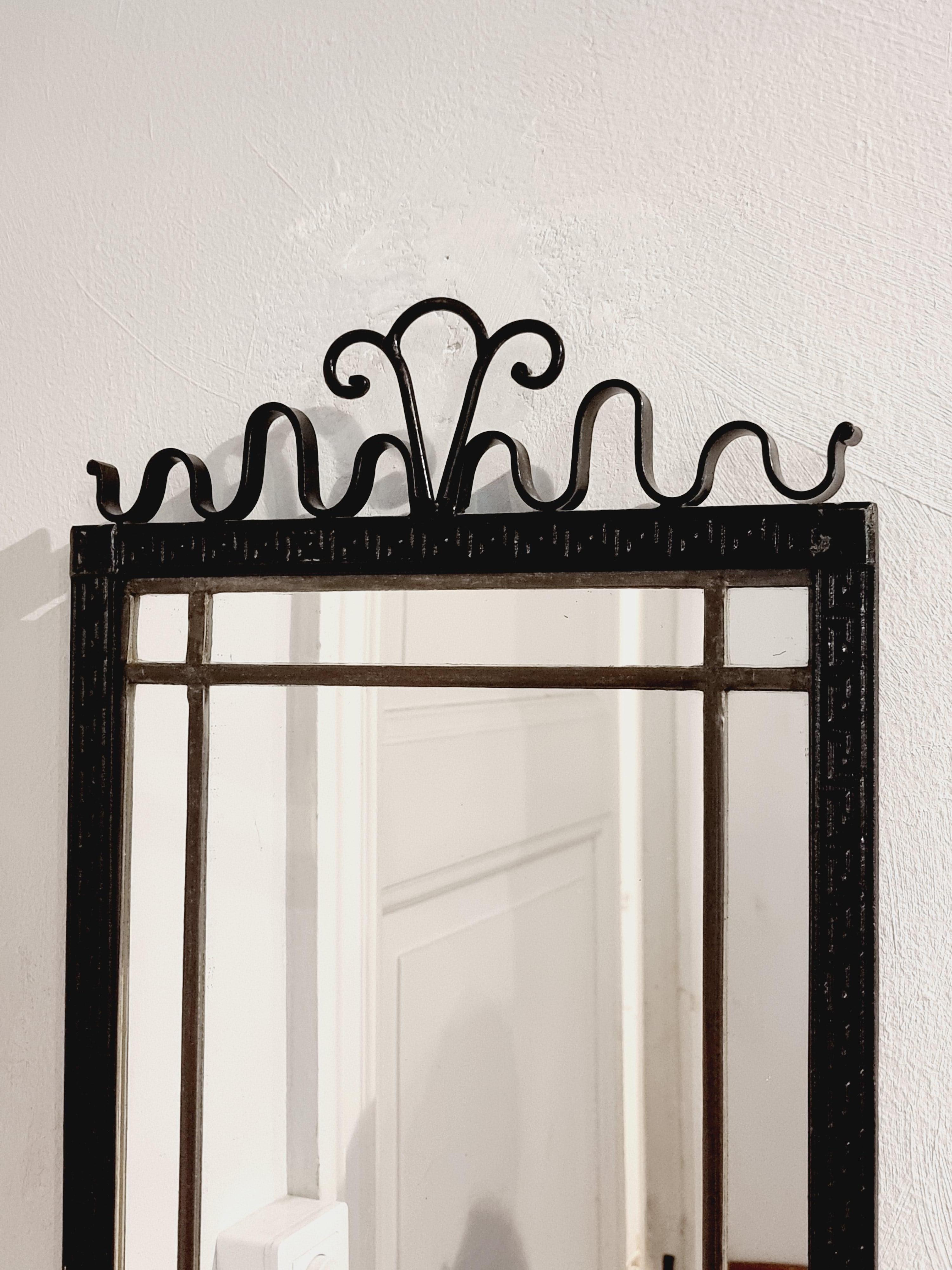 A unique wall mirror in black laquered wrought iron, with decor of waves, meander patterned frame. 

Swedish Grace, 1930s in the manner of Arvid Böhlmark, prominent swedish lamp manufacturer. 

In good condition, normal/smaller signs of age and