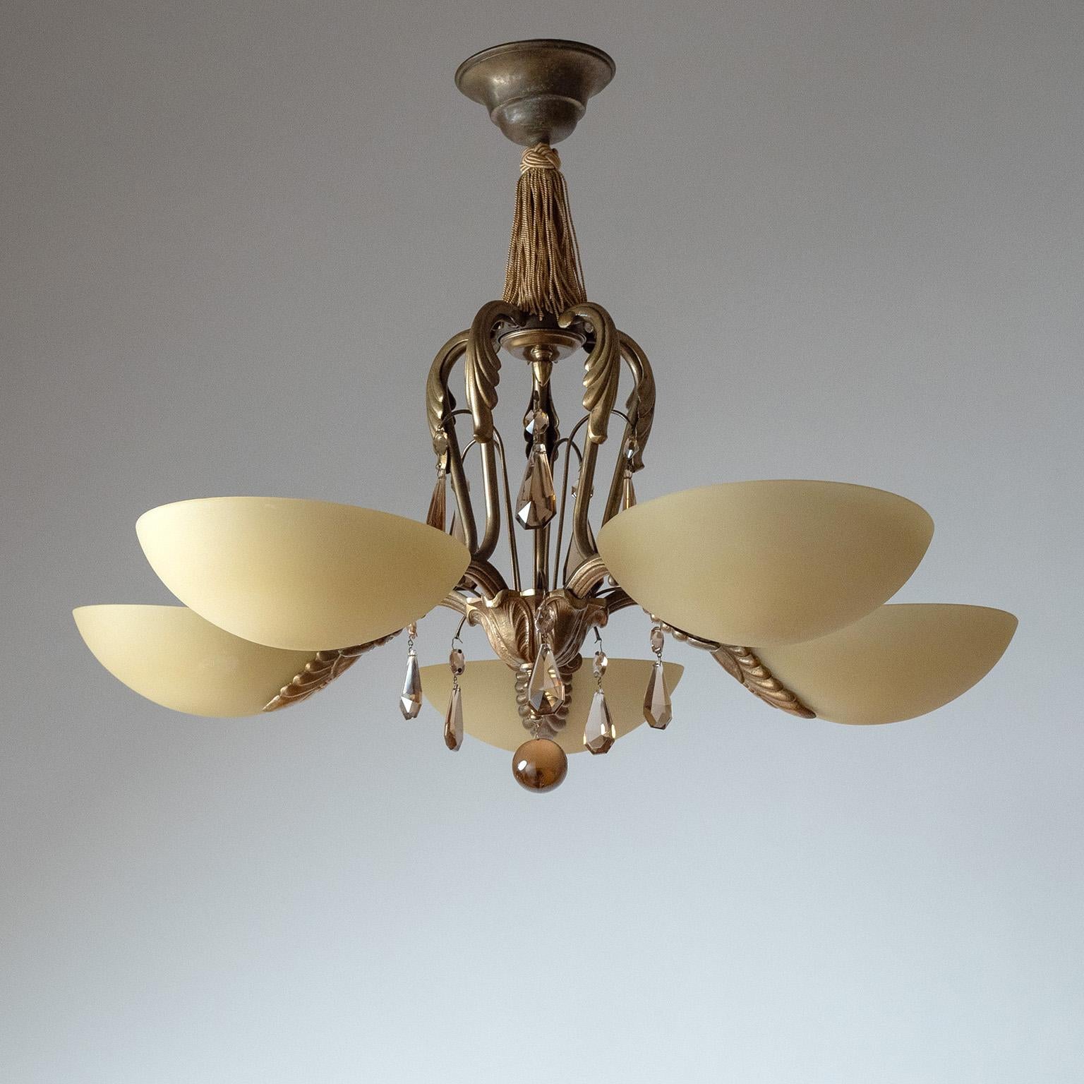 Extravagant Swedish Grace brass and glass chandelier from the 1930s. Five-arm structure with floral cast brass and smoked crystal glass decorations. Five pastel-yellow colored glass diffusers with a frosted finish. Very nice original condition with