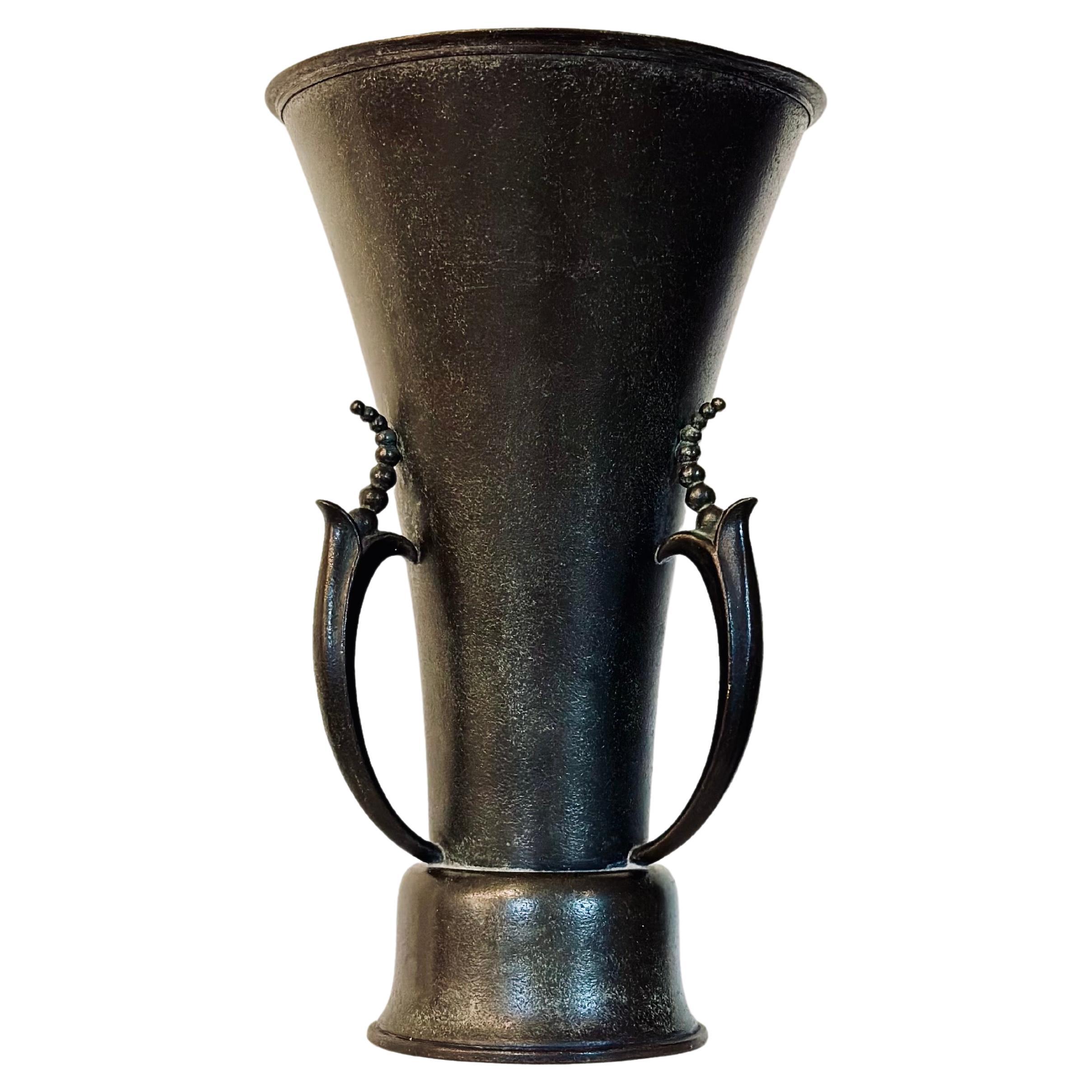 Elegant patinated bronze vase from Ystad Metall. Wide mouth, tapering towards the base that is adorned with beautiful flowers. Marked 
