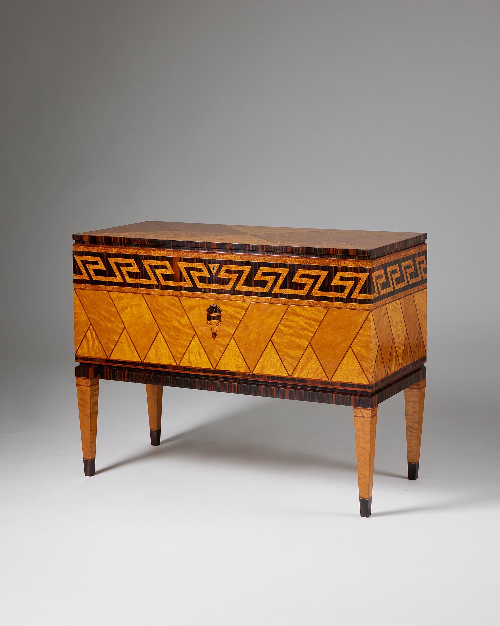 Swedish grace cabinet, anonymous,
Sweden, 1930s.

Veneered birch and Zebrano wood inlays.

This cabinet exemplifies the Swedish Grace style that emerged during the 1920s and 30s. The main body of the cabinets is decorated with geometric marquetry,