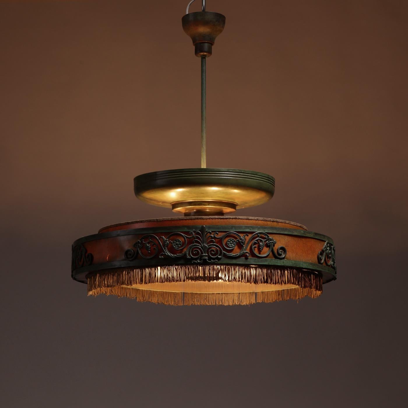 Swedish Grace ceiling lamp, green-lacquered metal, glass, leather, fringe decor, Sweden, 1930s.

Swedish Grace ceiling lamp, made by a Swedish cabinetmaker, 1930s. Made from green-lacquered metal, glass, leather, and original fringe decor. The piece