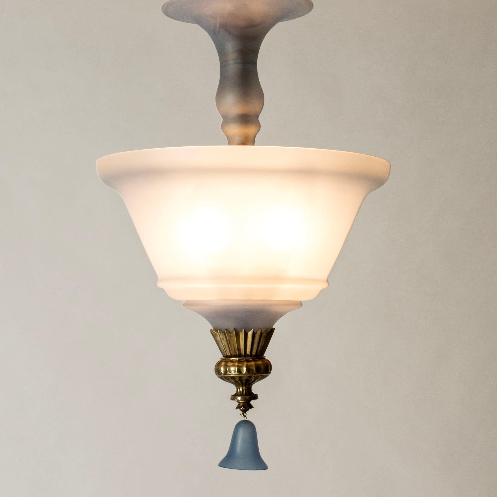 Beautiful flush mount ceiling light by Simon Gate, in a Swedish Grace design. Blue colored frosted glass with a glass bell hanging from the bottom. Lovely brass decorative details.
