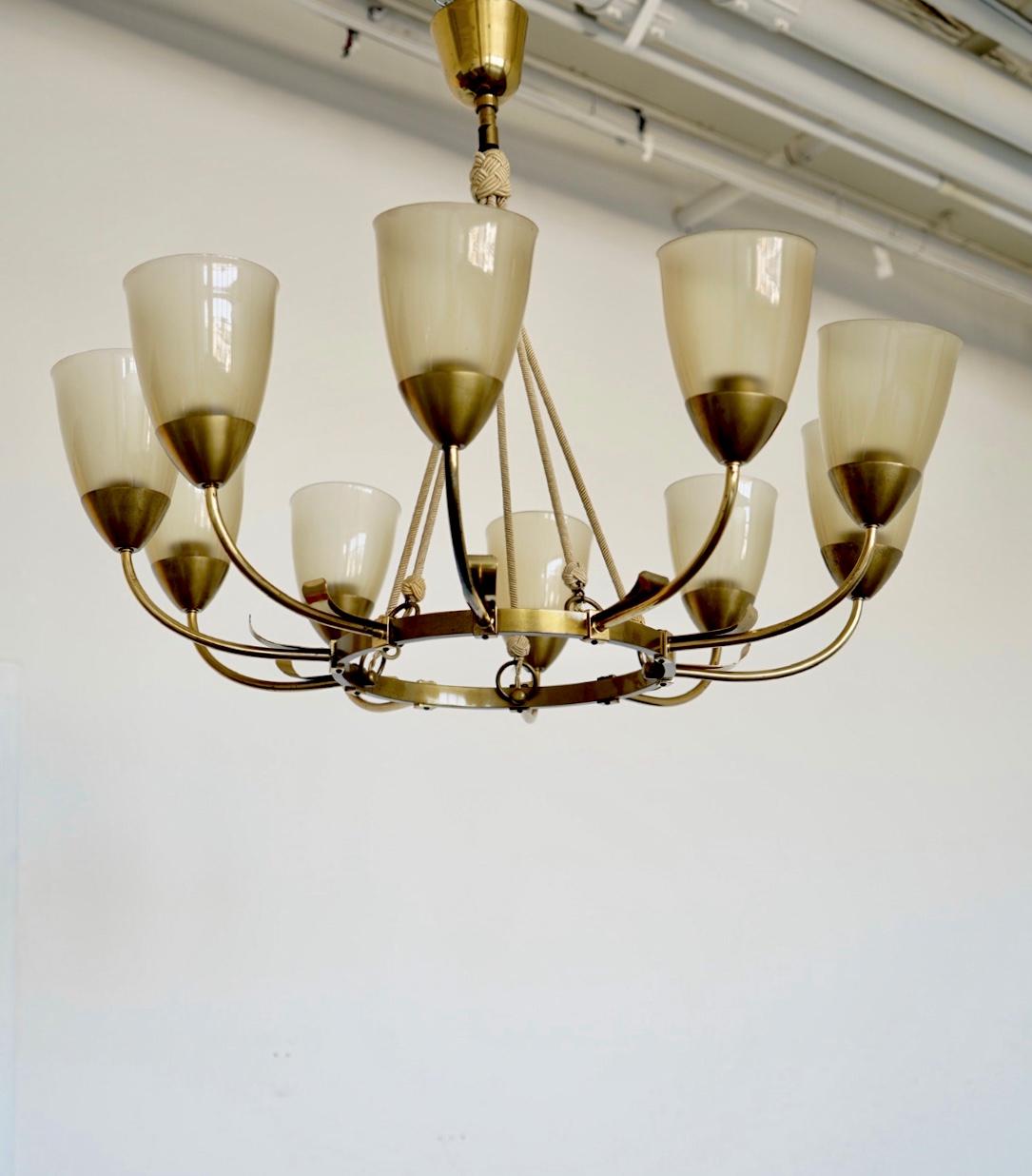 A Swedish Grace Chandelier. Polished brass and glass. 
10 E27 sockets, original glass shades, existing wires. Rewiring available upon request.