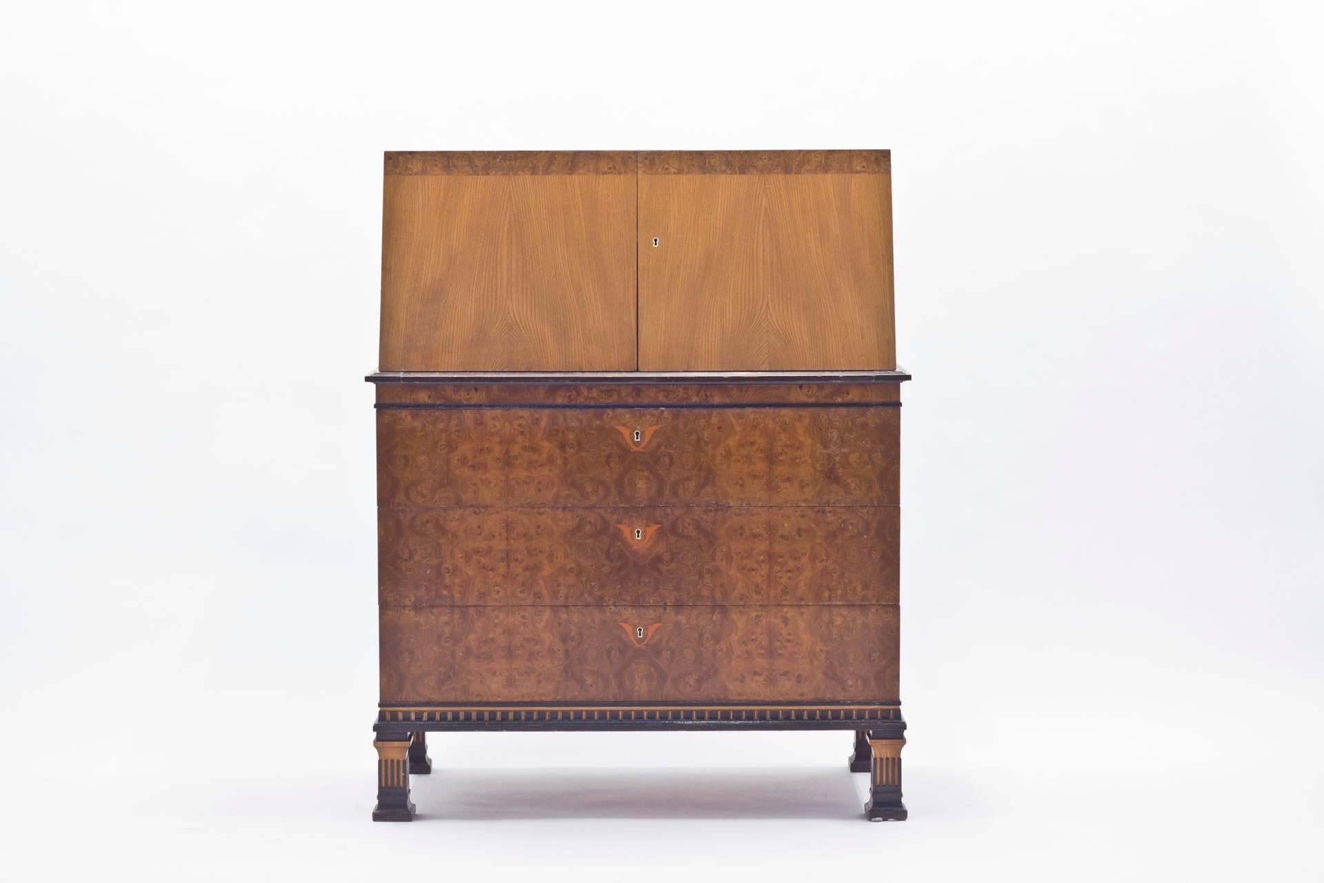 This Swedish grace chiffonier was designed by Erik Chambert during the 1930s for his own company, Chamberts Möbelfabrik. It displays a very high quality of craftsmanship, with a wide variety of different exotic wood inlays. Among those are rosewood,
