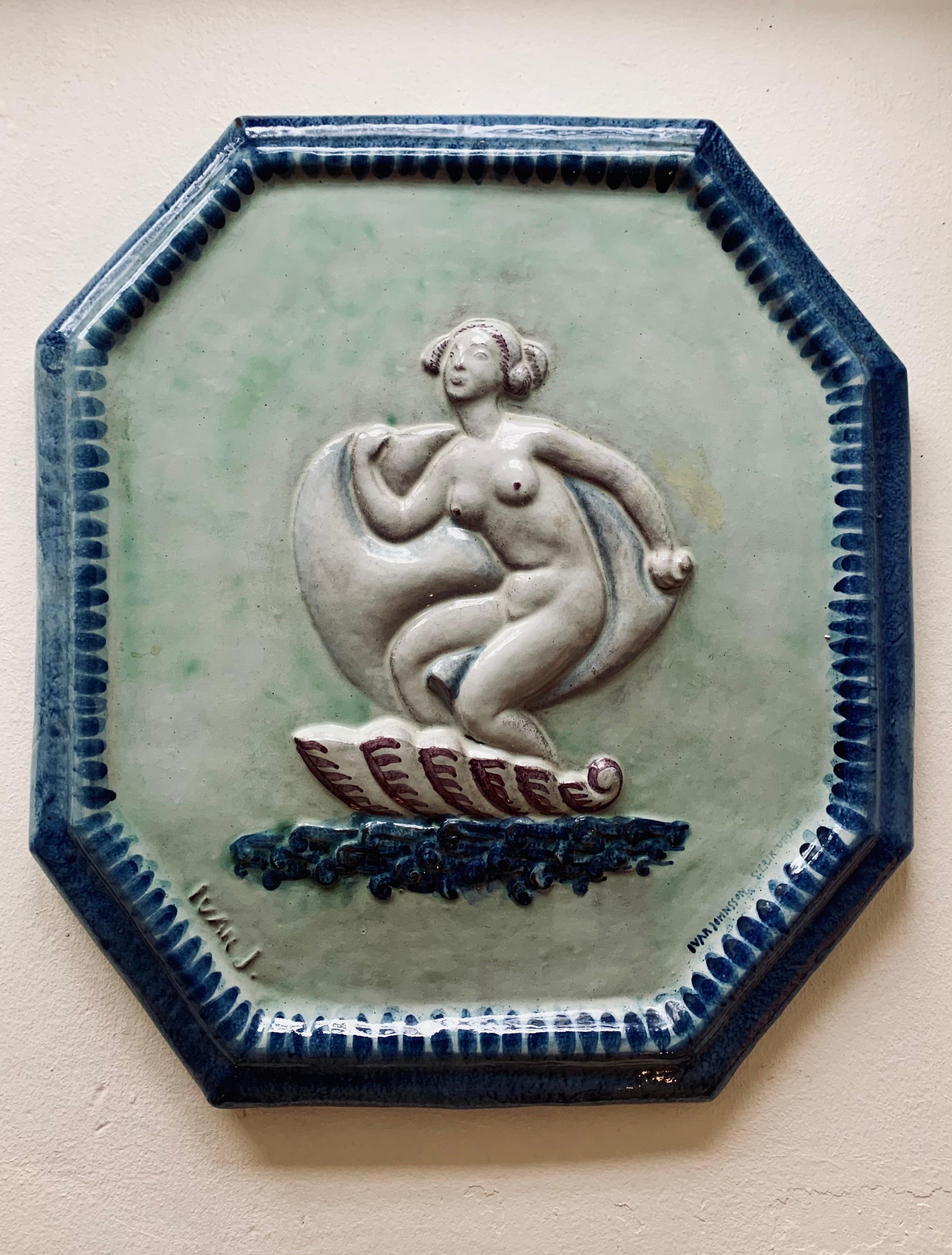Faience wall relief by Swedish artist Ivar Johnsson (1885-1970) made at the S:t Erik factory, Upsala Ekeby, 1919-1920s. Octagonal shape depicting Venus on a shell. Signed and marked S: Erik Upsala, also signed 'Ivar J.' in the cast. Composed for KTH