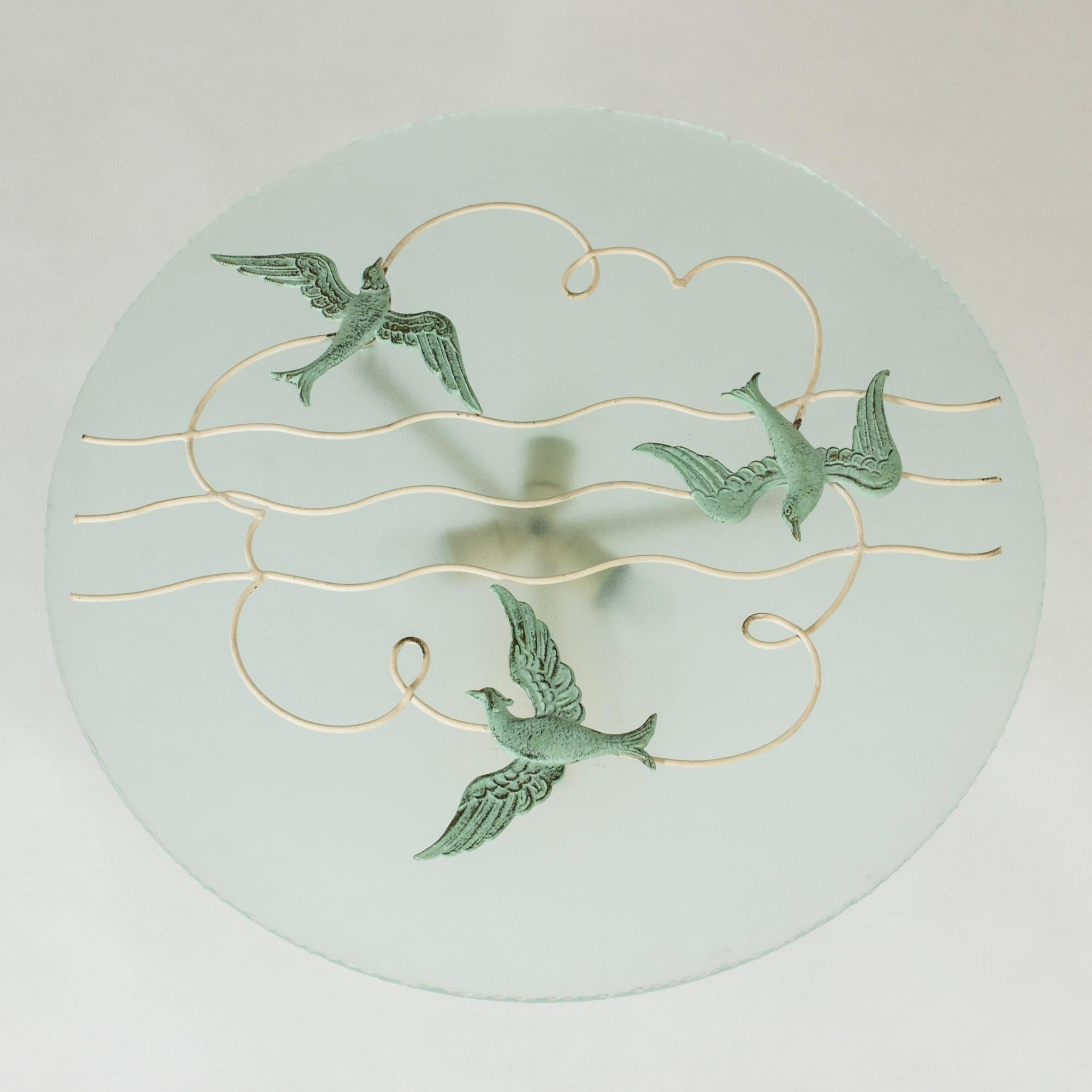 Stunning, large Swedish Grace flush mount ceiling light from Bjerkås Armatur, made from a sphere of frosted glass. Embellished with bronze decor of birds, graphic cloud and waves.