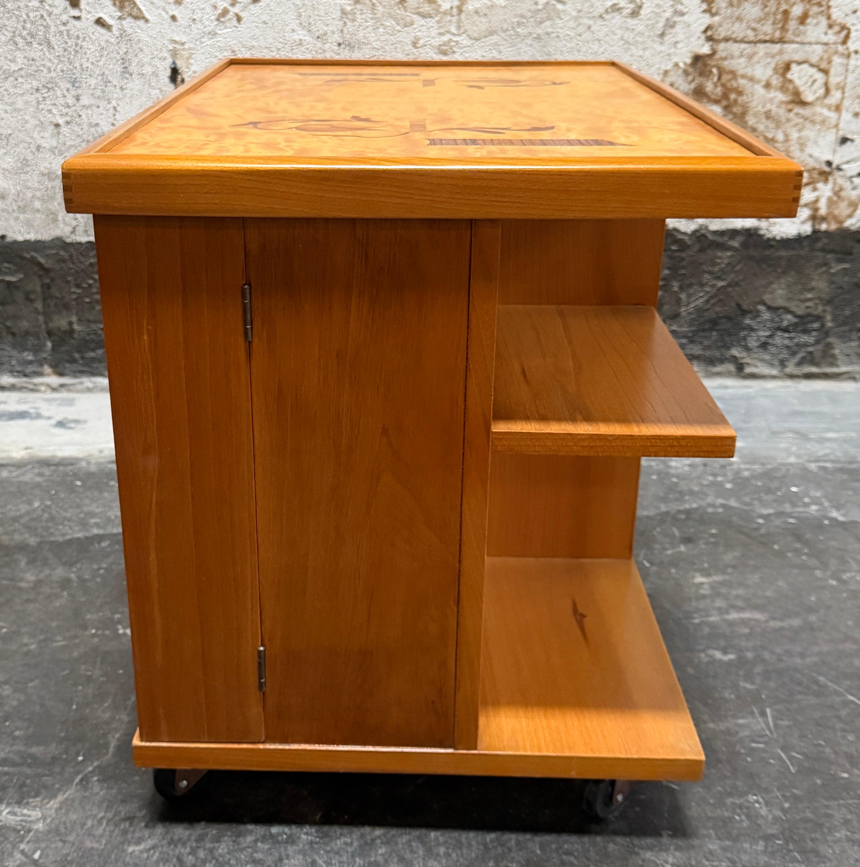 Multi-functional rolling cabinet that is an outstanding example of the Swedish Grace (Art Deco) movement, embodying functional beauty and exquisite craftsmanship. This style of furniture was historically referred to in Sweden as a 