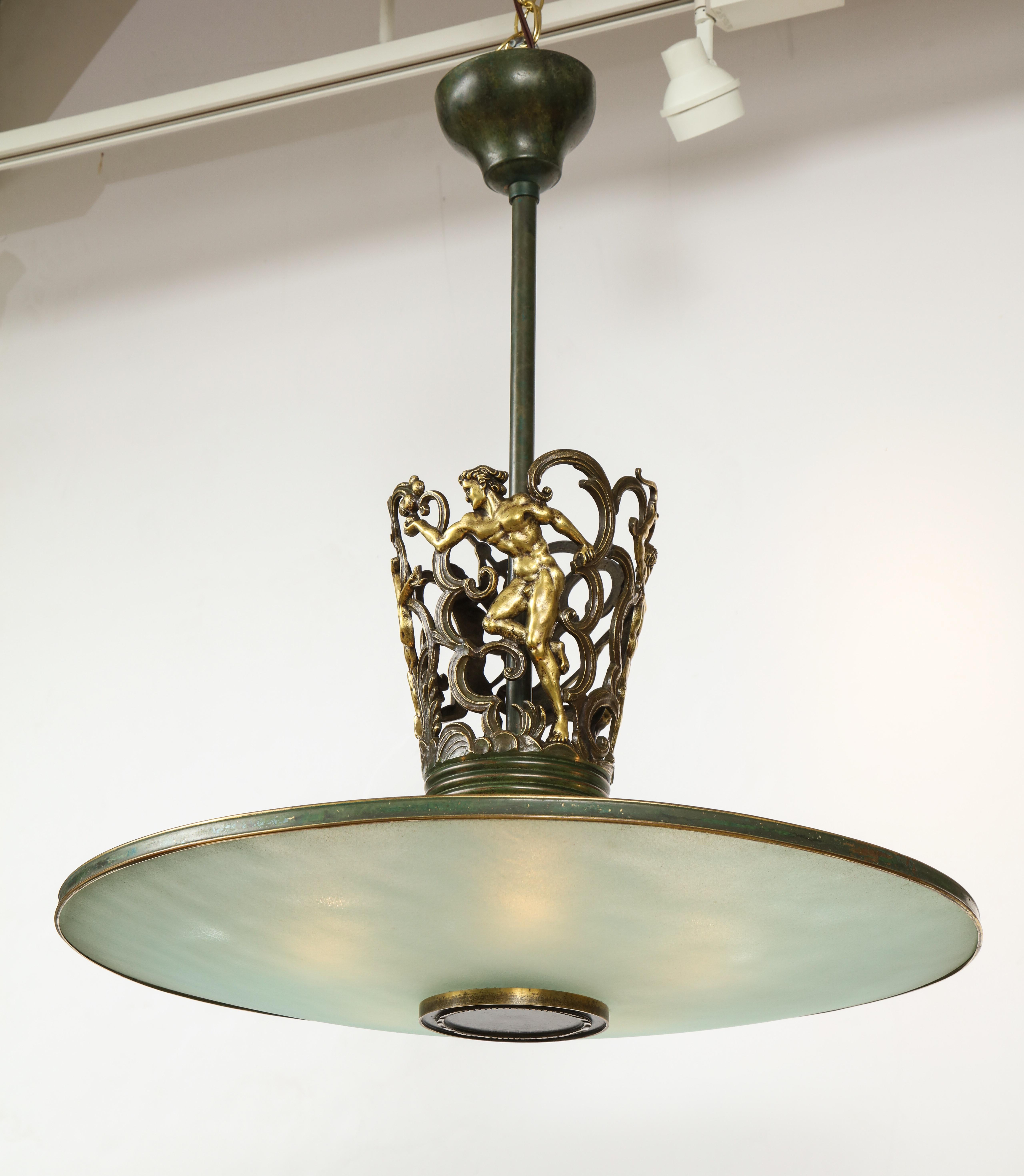 A Swedish Grace patinated bronze and frosted glass chandelier, circa 1920s, the central stem with cast foliate and scrolled banding, classical nude figures and animals, the circular frosted glass dish with a channeled banding ending with a disc