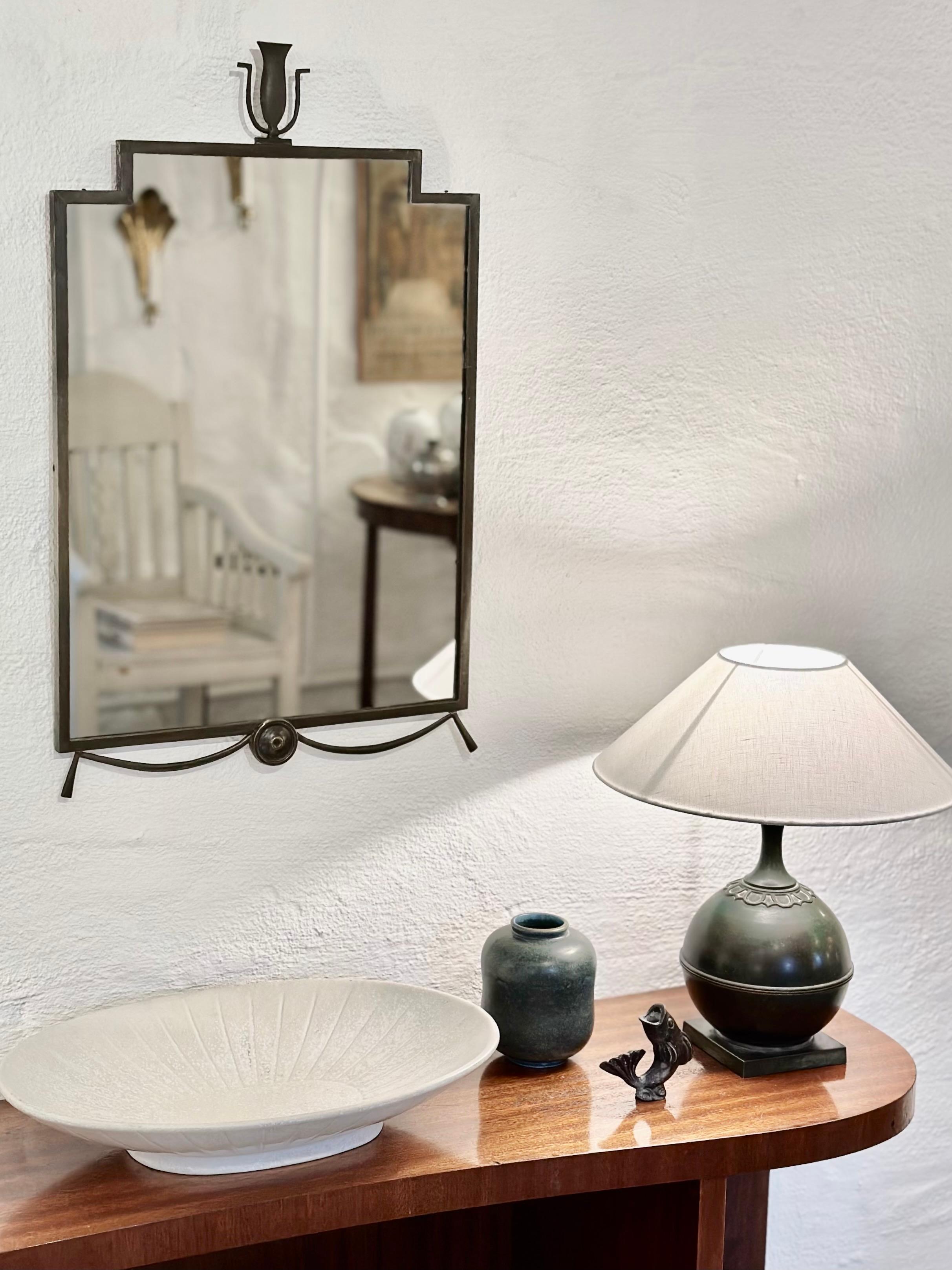 Rare and decorative Swedish Grace patinated bronze mirror signed Gustav Melin, Sthlm, 1927. Beautiful clean and elegant design that makes a subtle statement in modern interiors. The piece is in good condition but has a repair welding where the ends