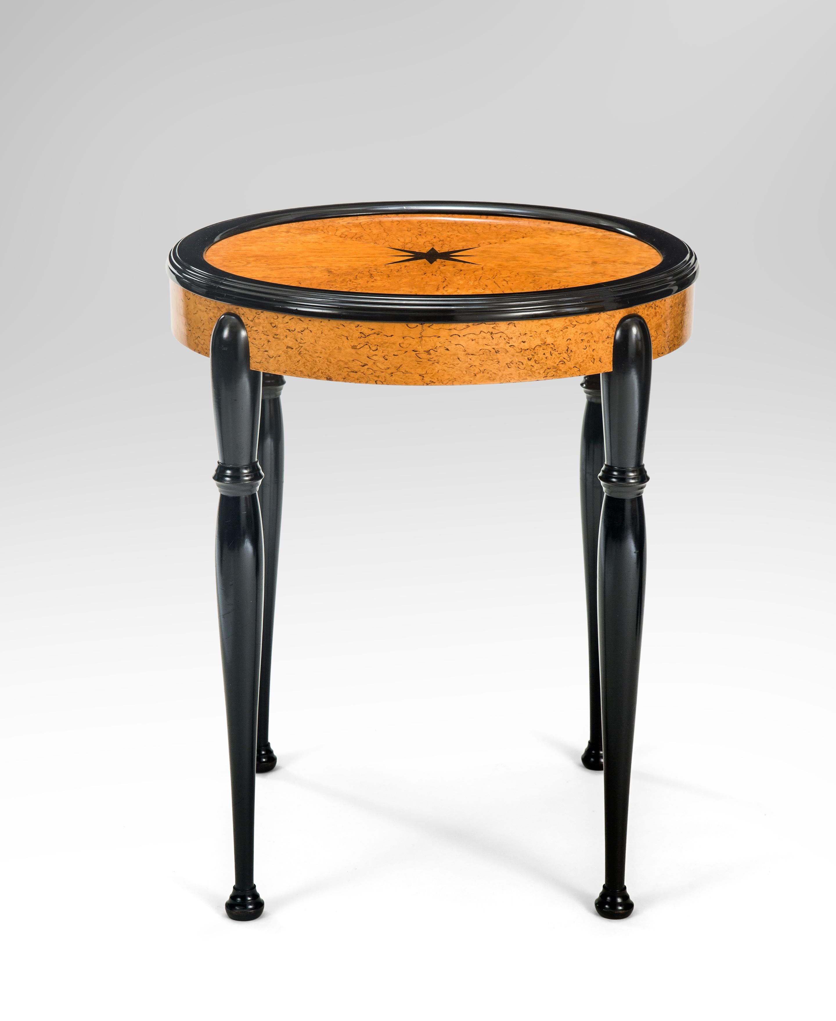 Swedish Grace Period Ebonized and Karelian Birch Round Table
Early 20th Century
This table is ready for stylish cocktails or serious reading material, either way it will grace your interior.
The round top with a smartly molded border and centered