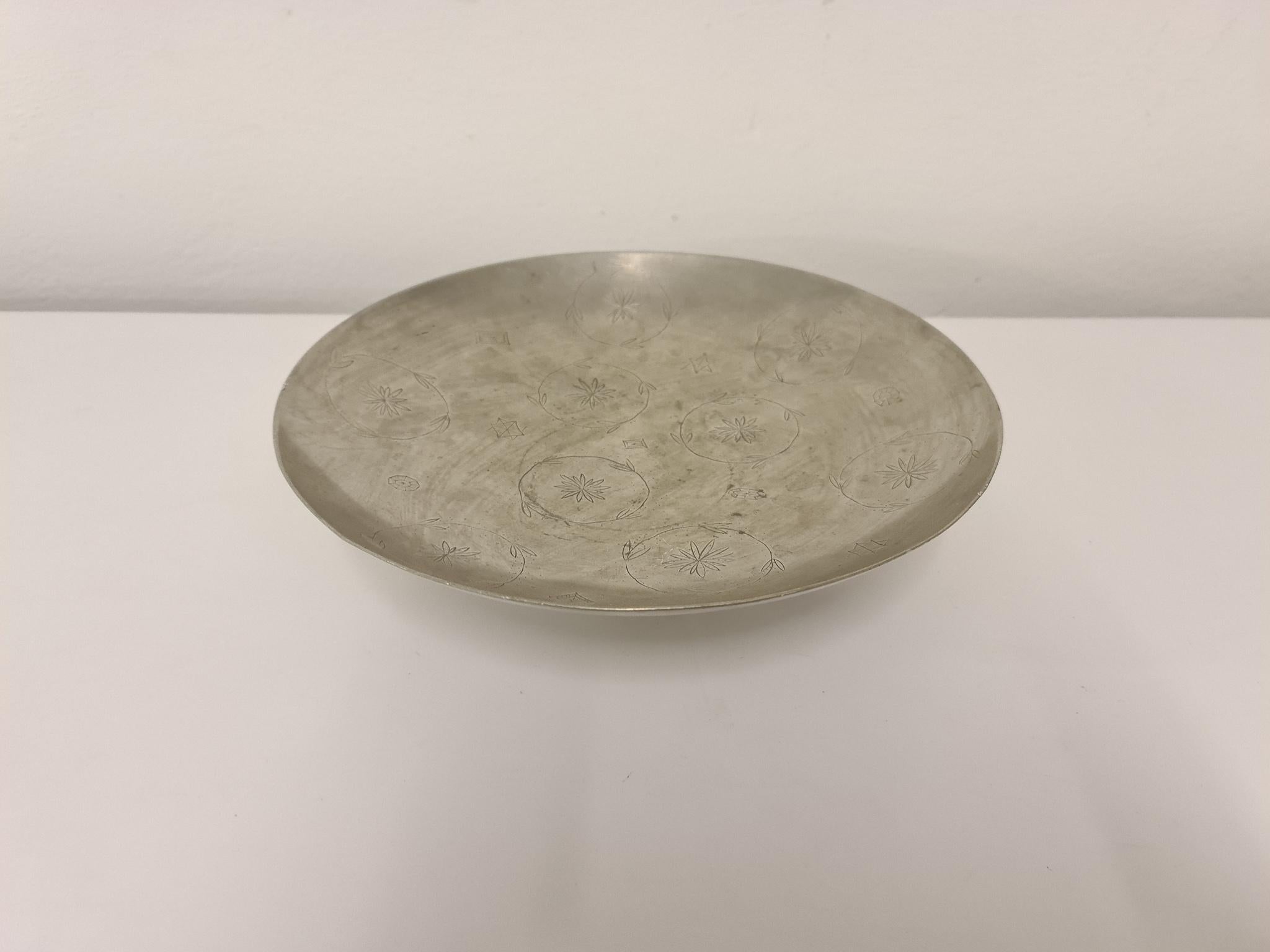 This simple but so graceful pewter bowl on foot was designed by Estrid Ericson who was the founder of famous Svenskt Tenn. The bowl itself has a playful pattern on the top. Made in Stockholm, Sweden, 1932.

Good vintage condition, mark on one of