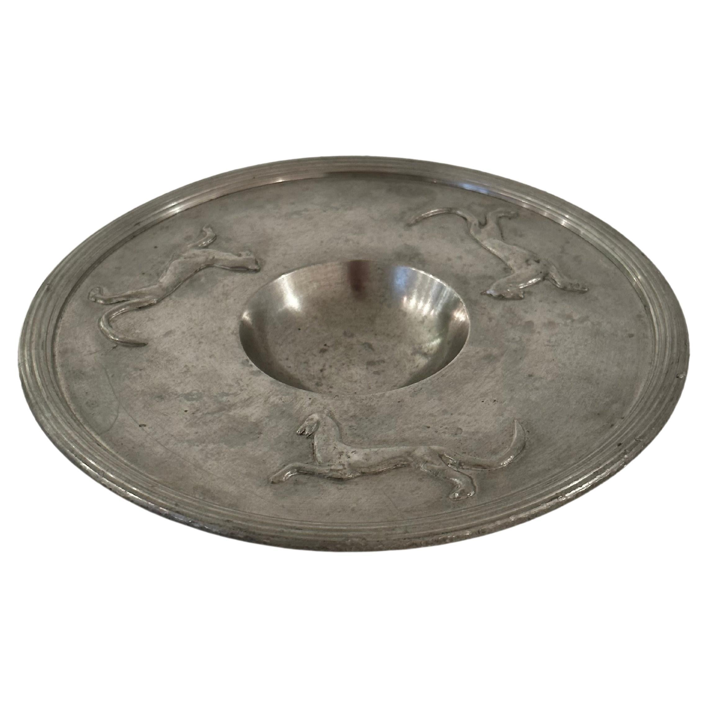 Swedish Grace pewter dish or bowl on foot from the early years of Svenskt Tenn (est. 1924). The wide rim has a relief decor of felines. Likely designed by Estrid Ericson, the founder of Svenskt Tenn. 

Height: 2 cm
Diameter: 18 cm. 