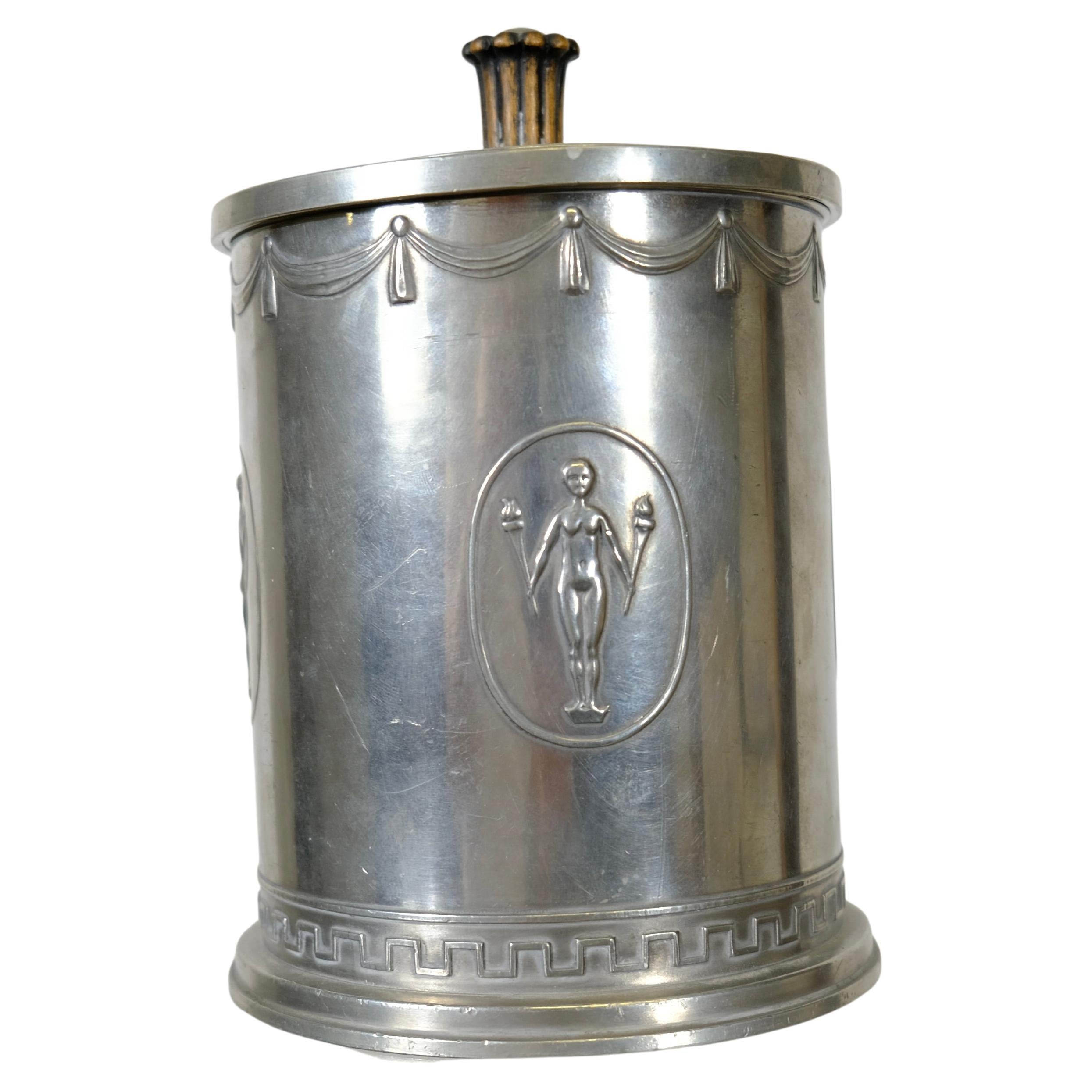 A Swedish Grace pewter jar with lid made by The company Schreuder & Olsson in 1927. This is a very typical object for its time and could have been used for cigars. 
The 1920s was an important period in Swedish design and has internationally become