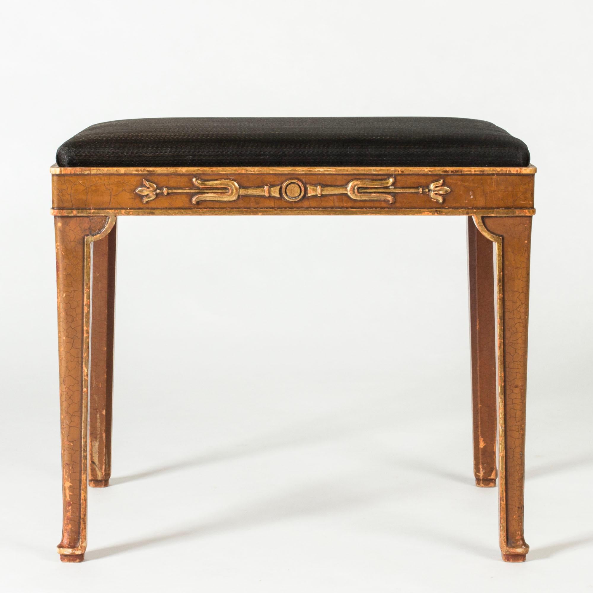 Elegant stool by Axel Einar Hjorth, model called “Ceasar”. Made from painted wood with gilded decor. Seat upholstered with horsehair fabric.