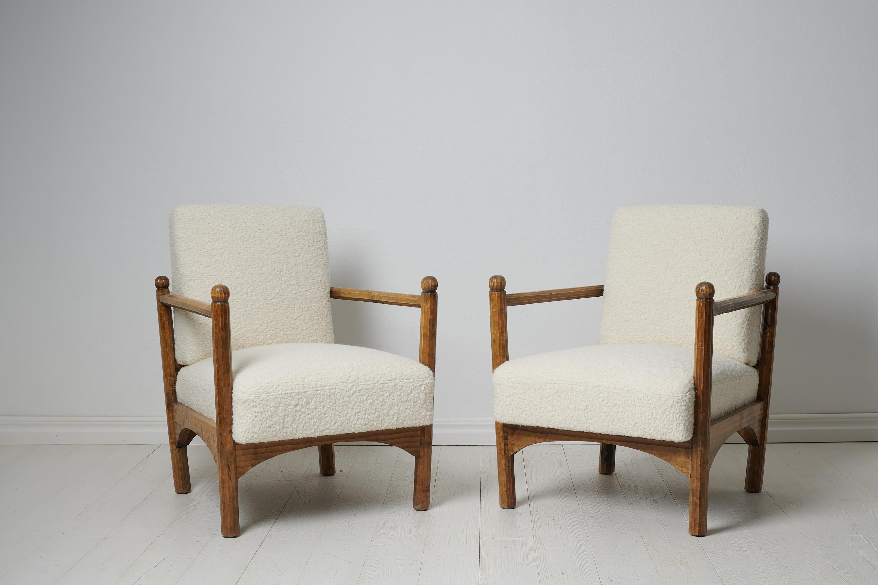 Swedish grace upholstered armchairs from the early 20th century, around 1920 to 1930 in Sweden. The armchairs are unusual and made in a style similar to that of Swedish designer Axel Einar Hjort. The chairs have a frame in stained birch and hand