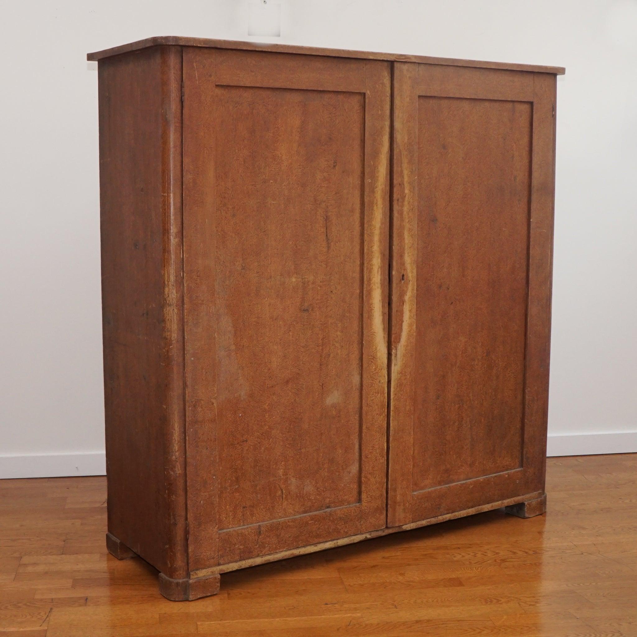 The antique Swedish cabinet, shown here, maintains its original grain-painted finish and displays a beautiful well-worn patina. Two doors open to six interior shelves. This is a simple cabinet that makes a big statement.