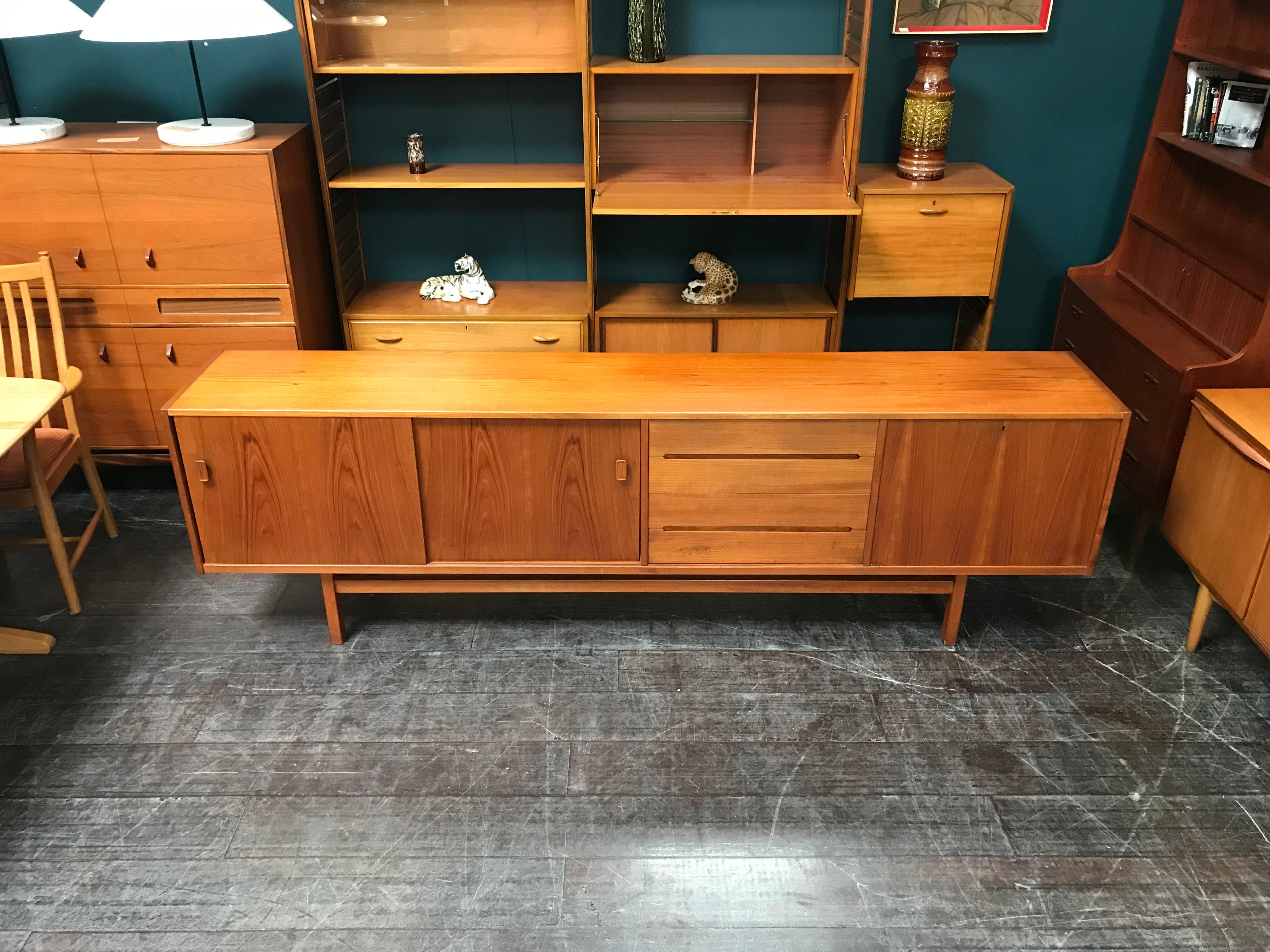 An elegant midcentury Scandinavian sideboard designed by Nils Jonsson for Swedish maker Troeds. In addition to its fantastic length, clean lines are a key attribute of the ‘Grande’. Nils Jonsson has excelled in this design, particularly in the