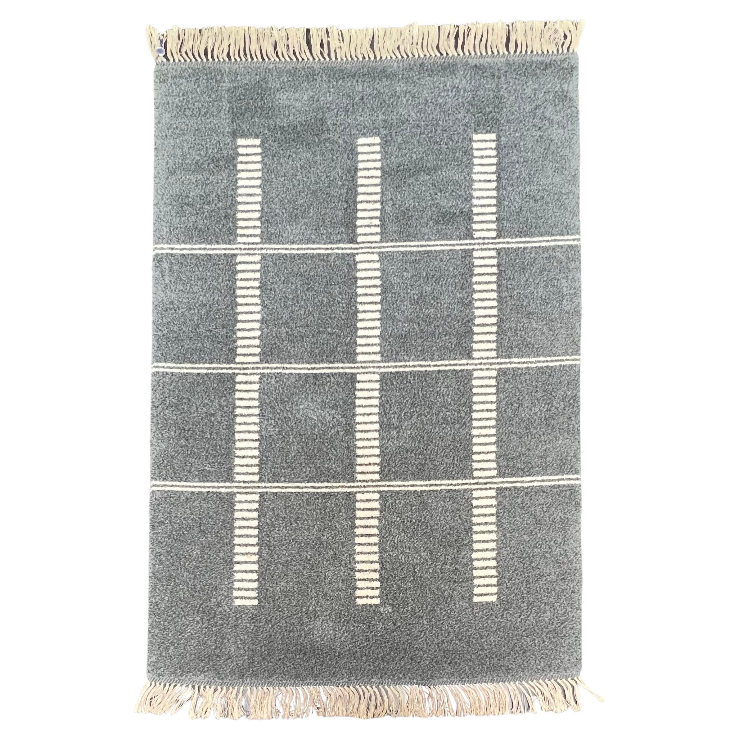 Swedish elegant grey and creme with geometric patterns. Made of wool. It is very soft and in excellent condition for its age. Designed and produced in the 1950s. All fringe are in good condition. It would be a good addition in any rooms of the house.