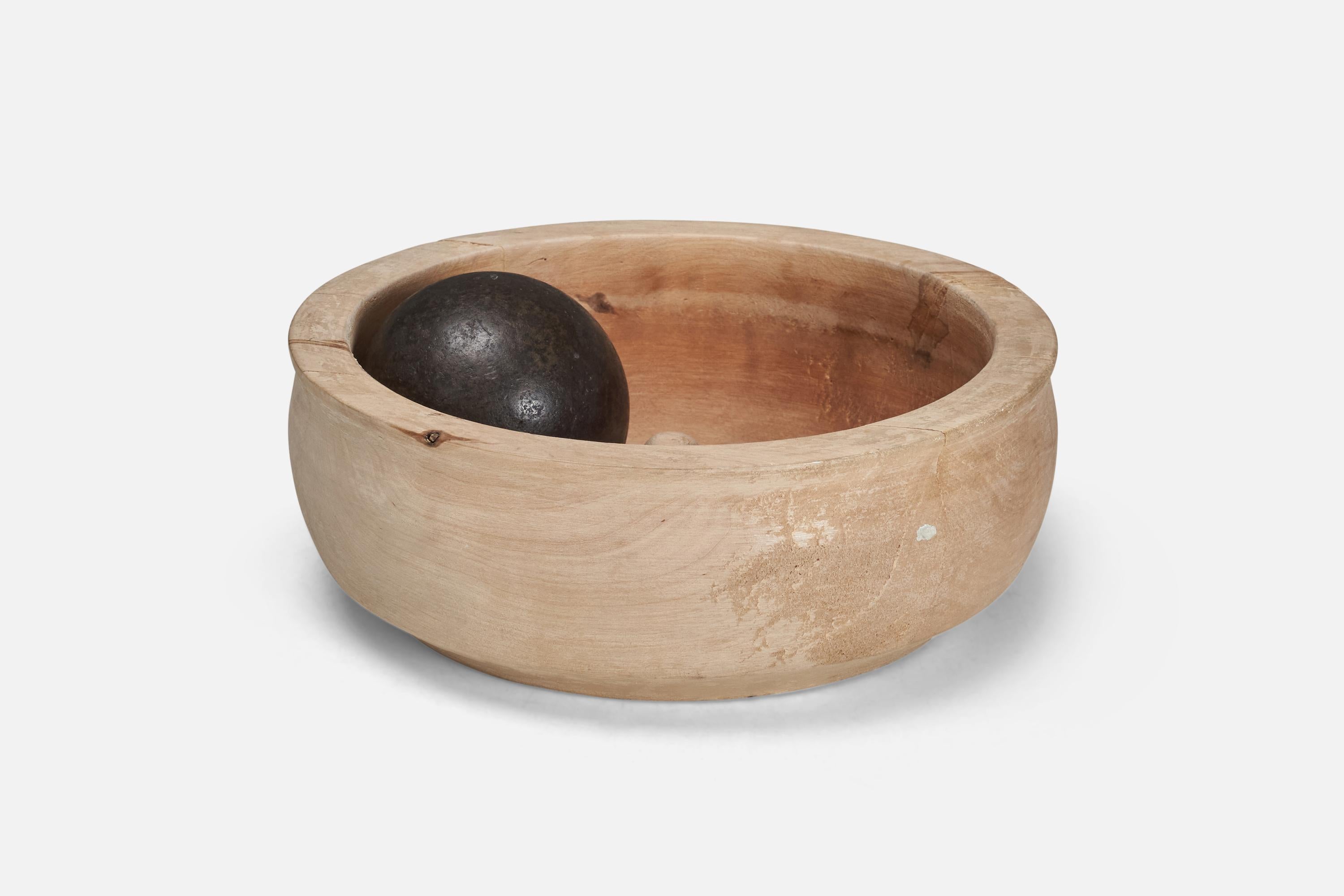 A signed Swedish craft grinding bowl. Produced in Sweden, circa 1960s-1970s. Hand-carved ash bowl with cast iron ball. Usually used for grinding mustard seeds.

  