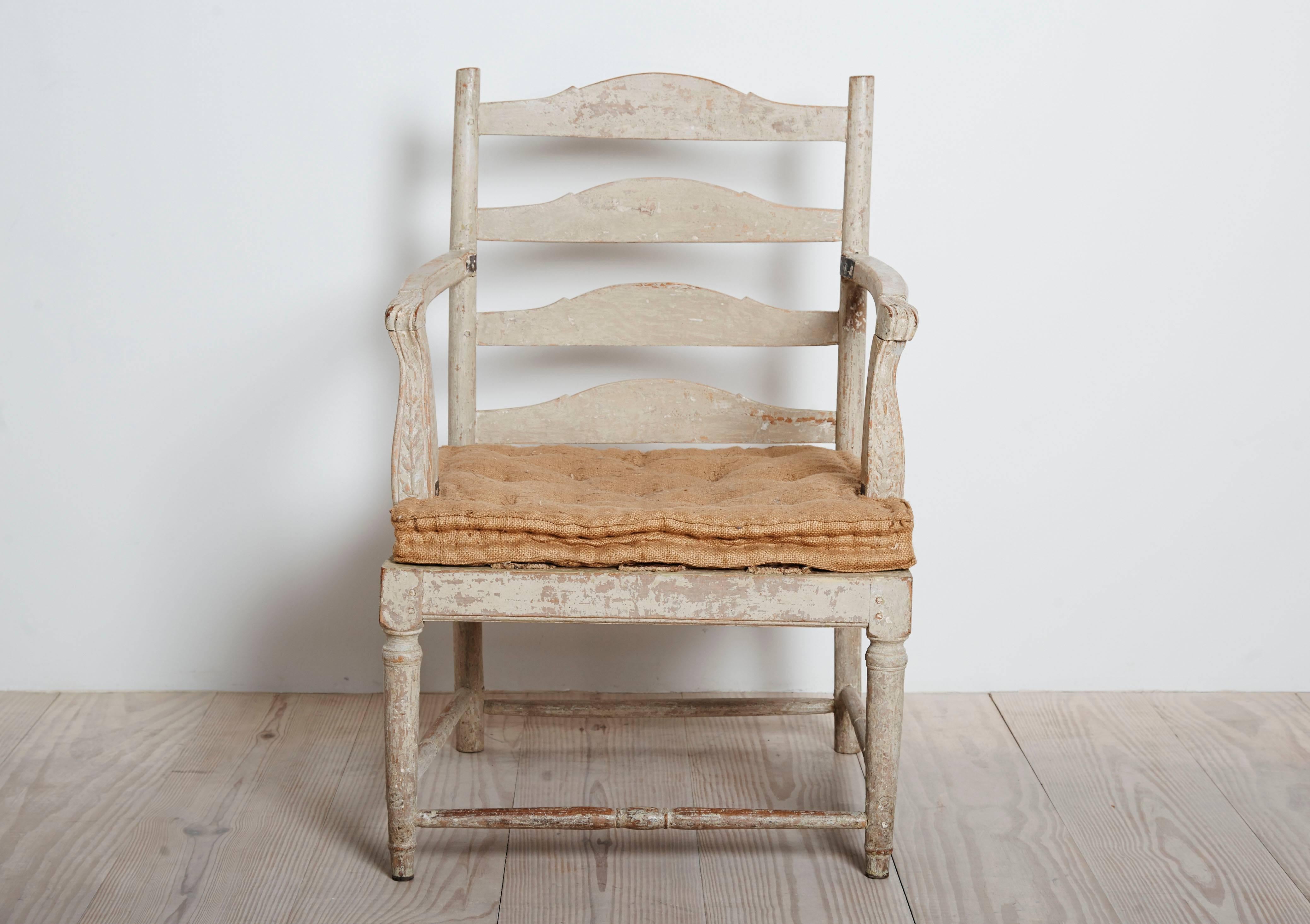 Exceptional and rare Swedish Gripsholm transitional Rococo / Gustavian armchair with unusual carvings and details, circa 1775, origin: Sweden, original paint with charming old repairs.
 
Provenance: Rosendals Slotts, Sweden

Gripsholm Slott, is a