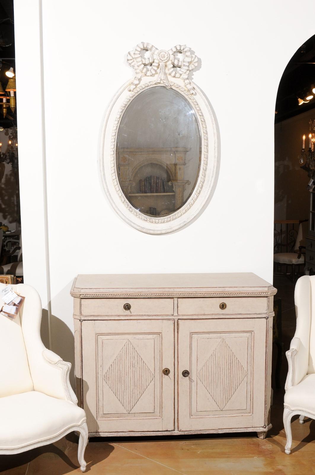 SOLD A Swedish Gustavian period painted buffet from the late 19th century, with canted side posts, diamond motifs and dentil molding. Created in Sweden during the last quarter of the 19th century, this painted buffet features a slightly raised top