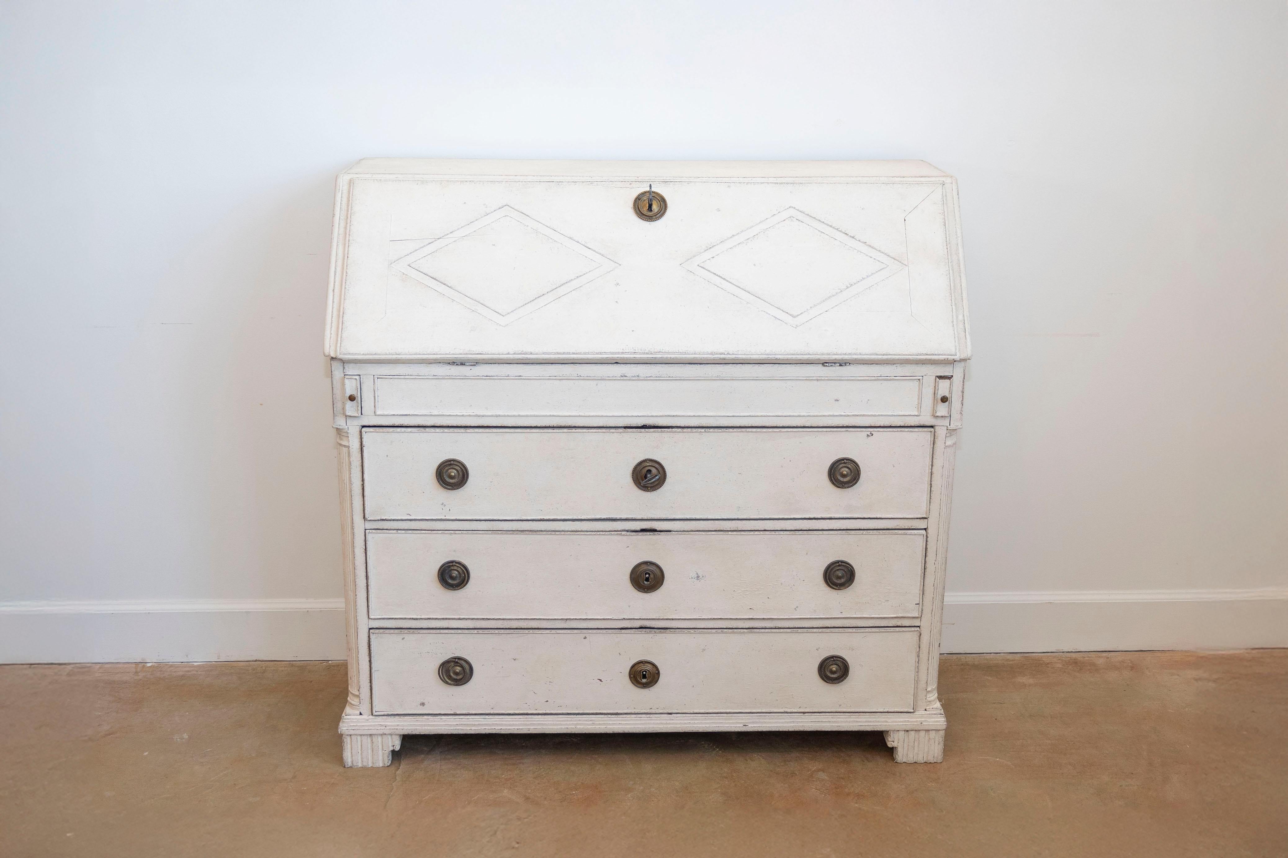 A Swedish Gustavian period slant front desk from the late 18th century, with carved diamond motifs, multiple drawers, original lock and key. Created in Sweden during the last decade of the 18th century, this fine painted secretary features a slanted