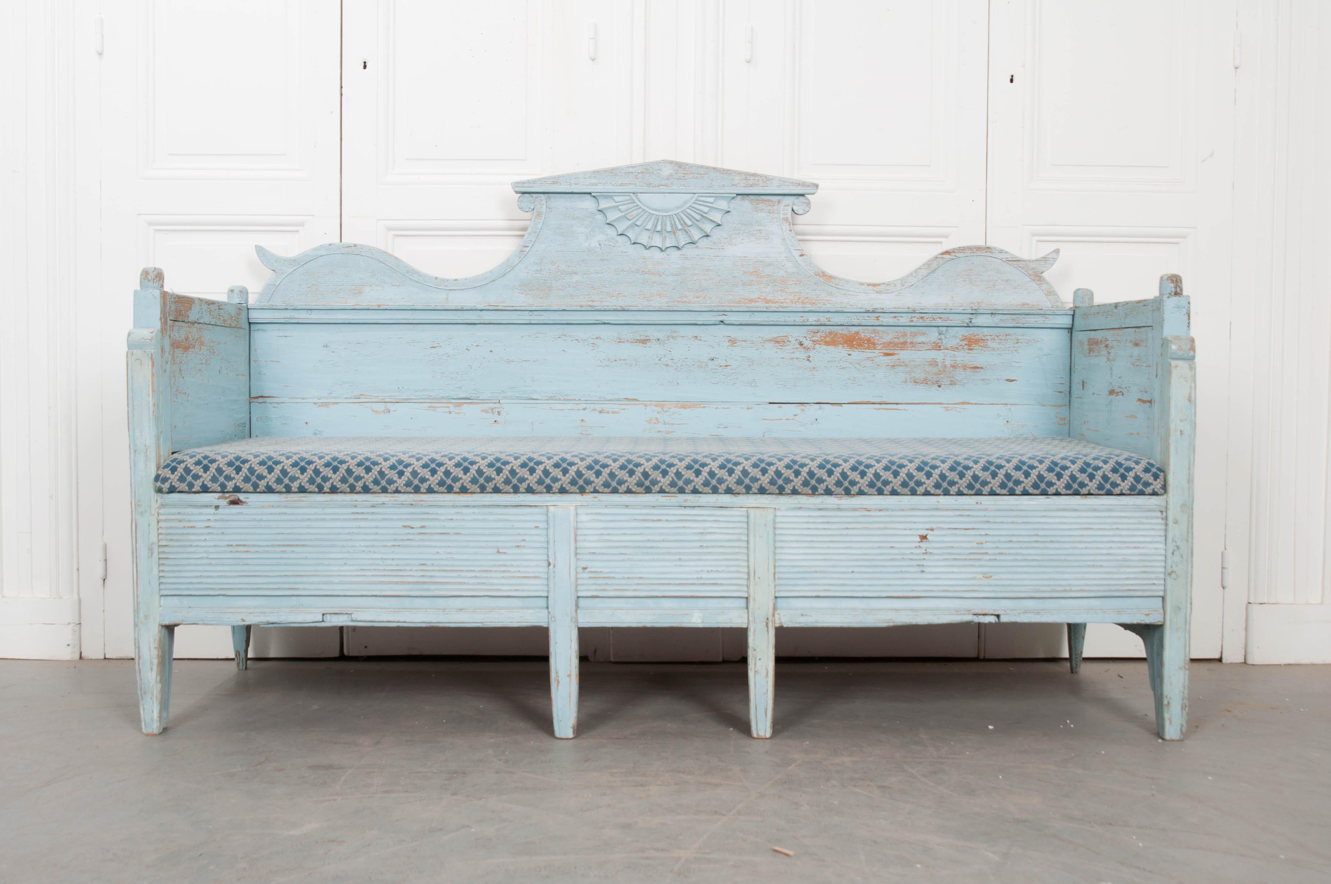 A spectacular powder-blue painted sofa, made in Sweden, circa 1880. The sofa is make of wonderfully carved wood that was painted a light, powder-blue color that has aged marvelously. The seat is upholstered in a patterned blue silk fabric. The back