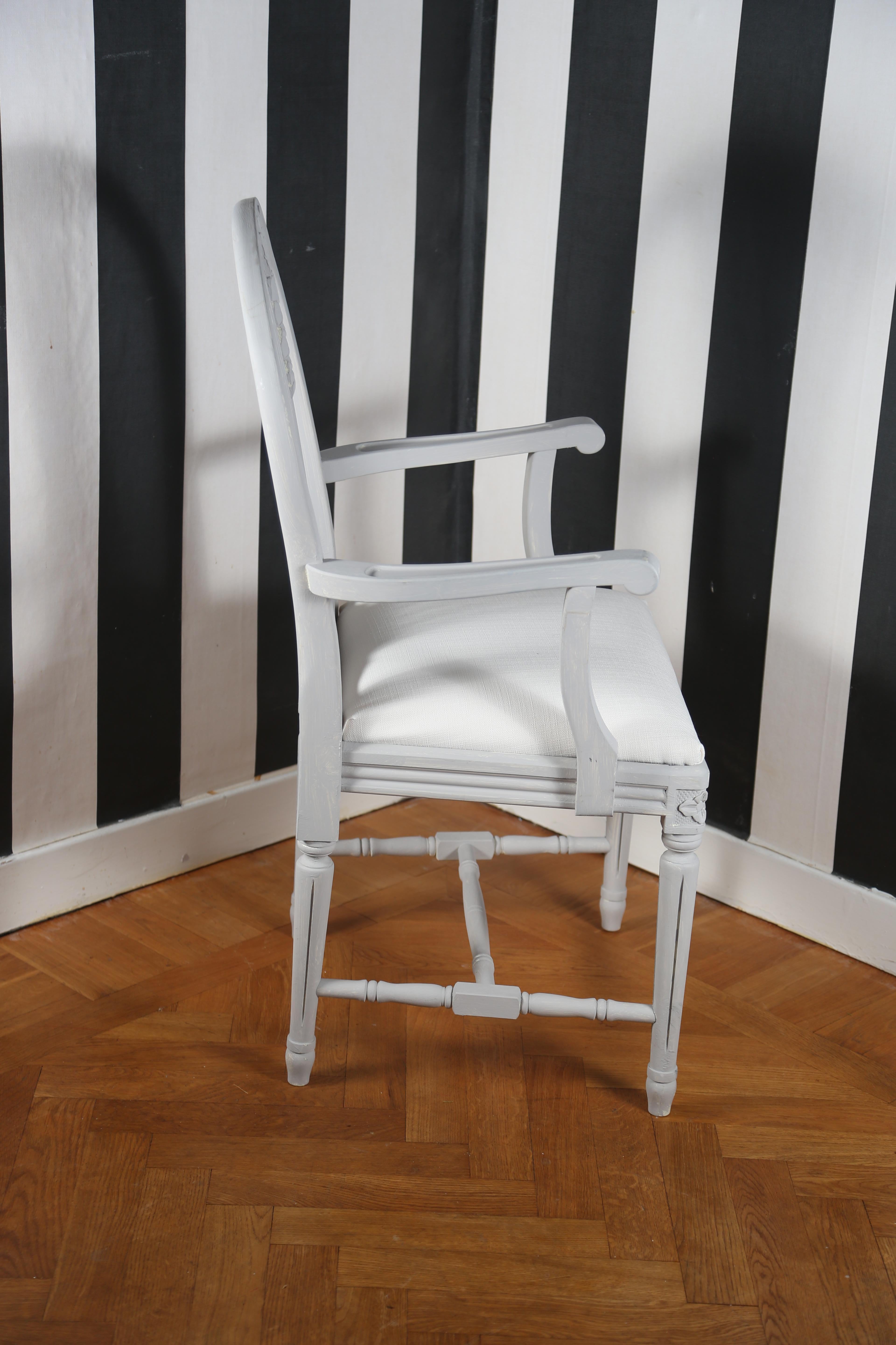 Swedish style painted armchair: the back has the weatsheaf details on it, the model is called Axet in Sweden, Rosettes top tapered fluted legs, bottom stretcher, painted in Swedish classical grey.

Measurements: H 95cm W51cm, 42cm L 41cm seat