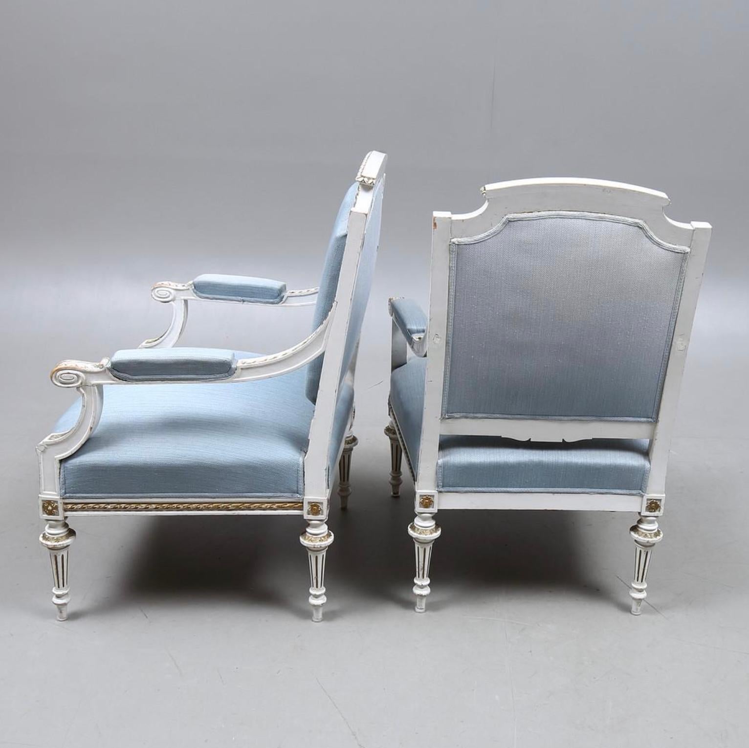 This is a Classic pair of original Swedish Gustavian early 1900s armchairs in probable original paint with highly carved detailing on the frames , arm and legs, unusual delicately fluted feet and wide seats 

The fully sprung seats on these