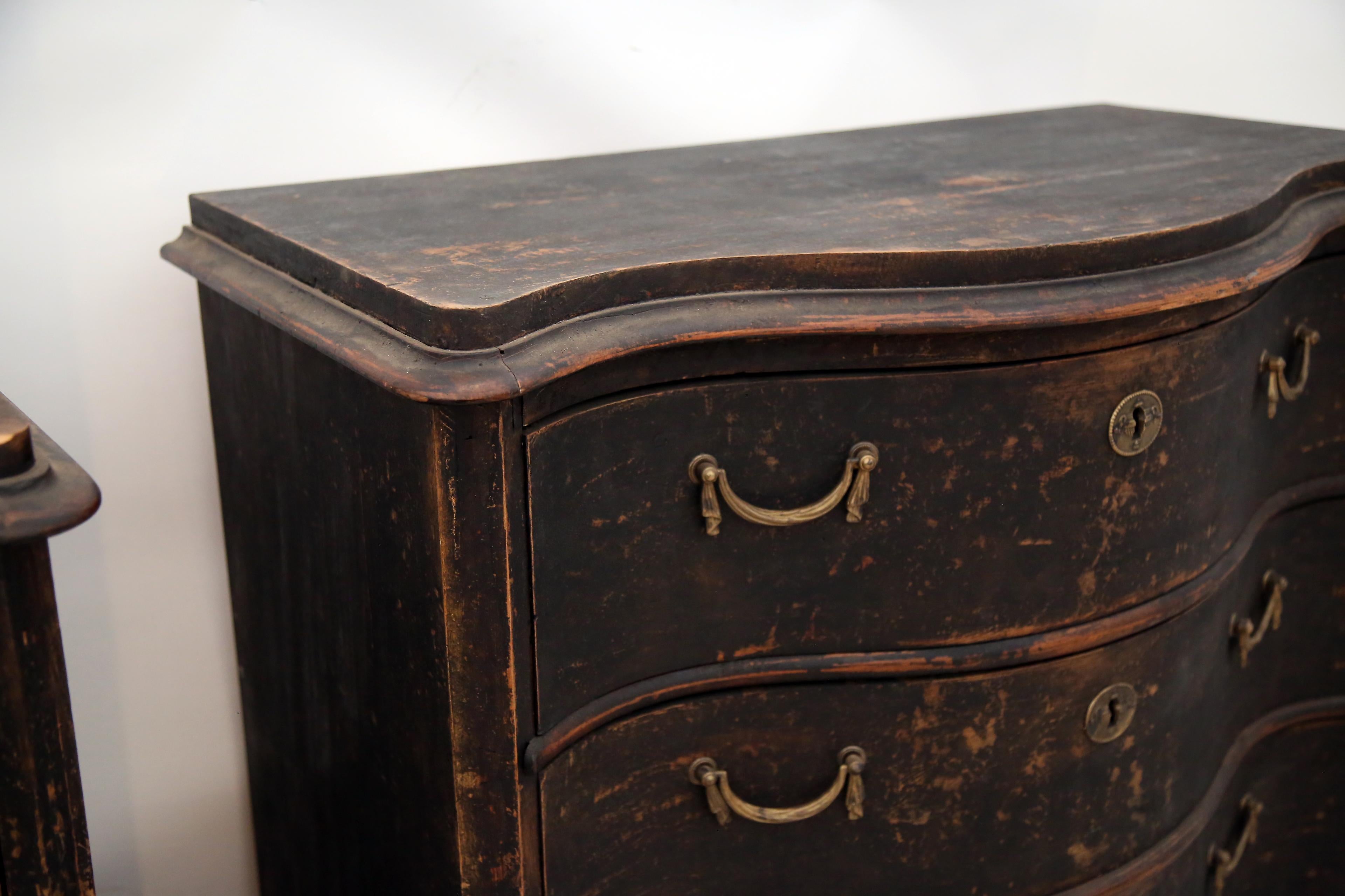 Stunning Rococo Swedish Commodes in a black color palette. Featuring original hardware with a newer paint finish. This pair can go in any design space. What a fantastic pair!