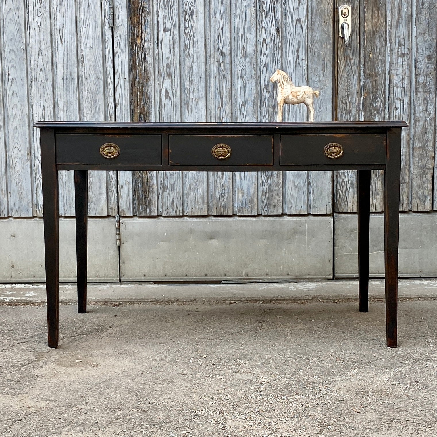 Swedish Gustavian ladies writing desk. Charming three drawer black painted desk with three drawers. Vintage embossed leather top and original brass hardware. Banded with Greek key pattern.